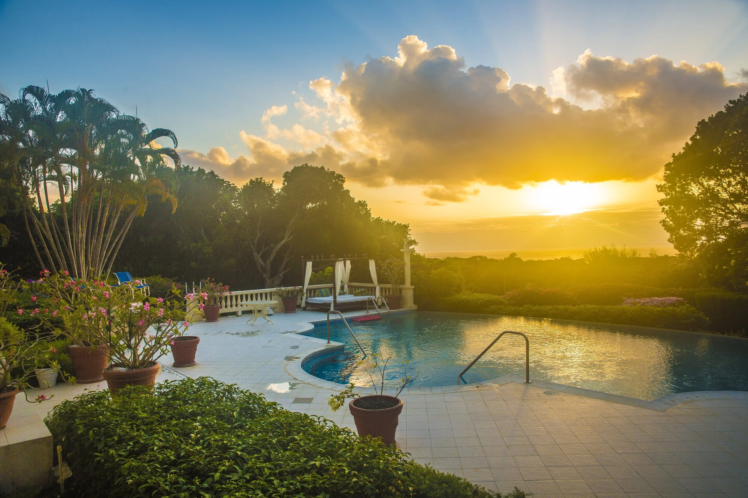 View over the infinity pool during sunset at Bohemia Sandy Lane luxury Barbados villa