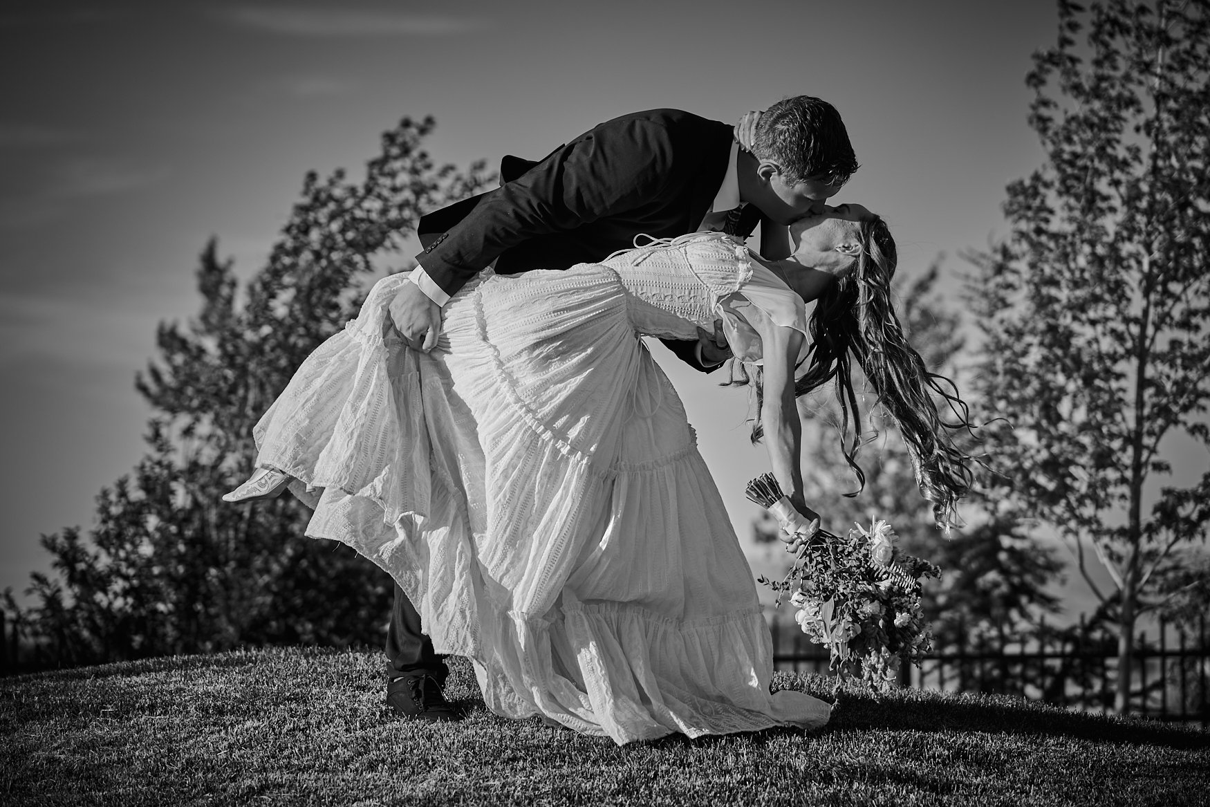 Black and white wedding photo of a bride and grom posing