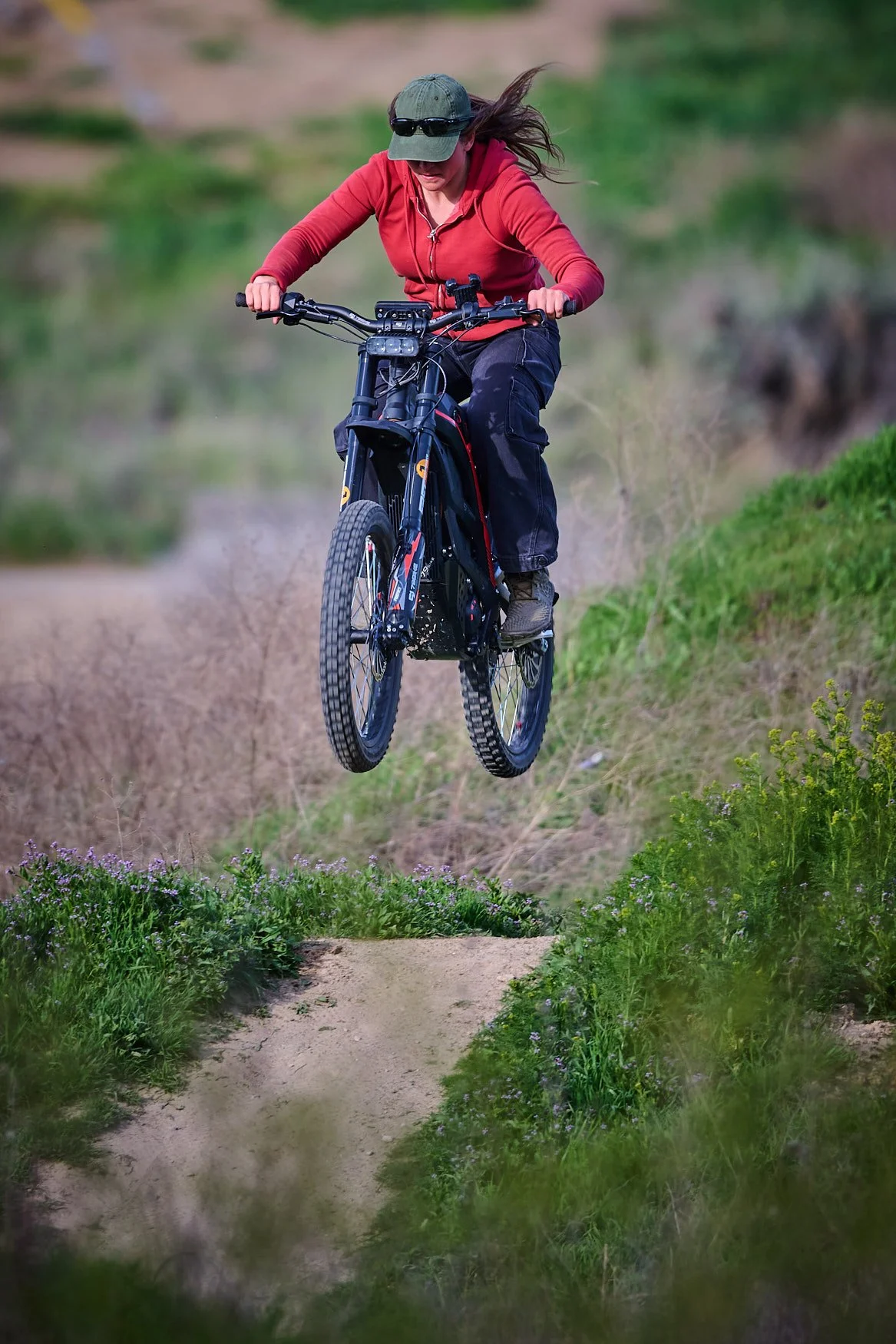 BMX rider perfoming a jump on a dirt track