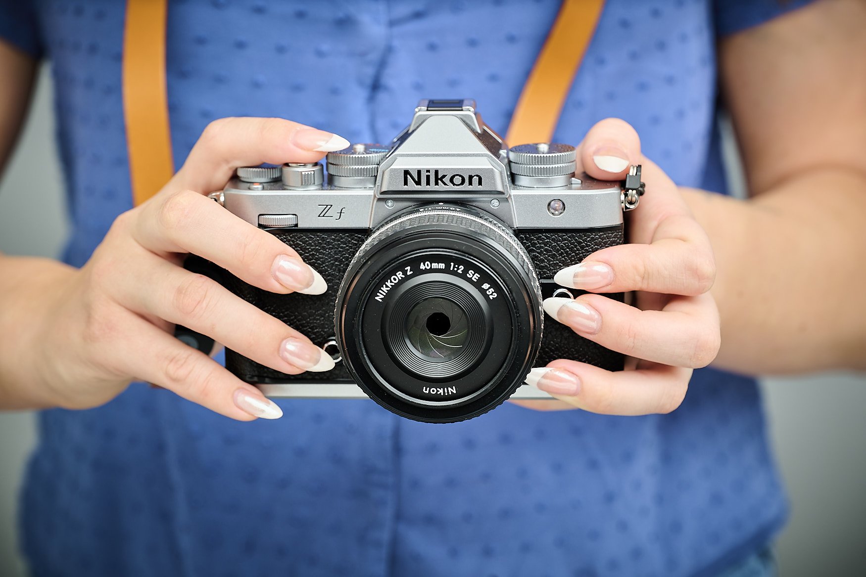 A women holding a Nikon Df camera