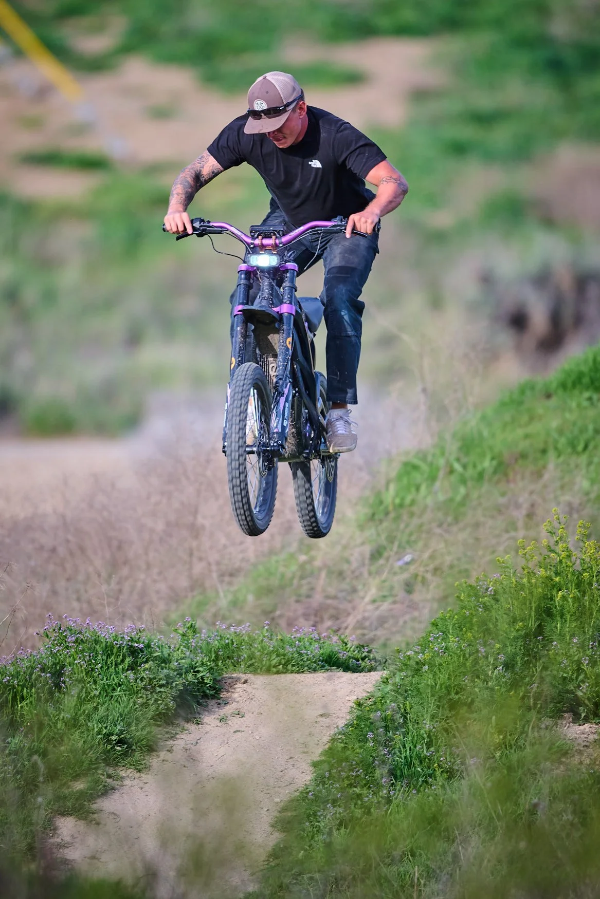 BMX rider performing a jump on a trail