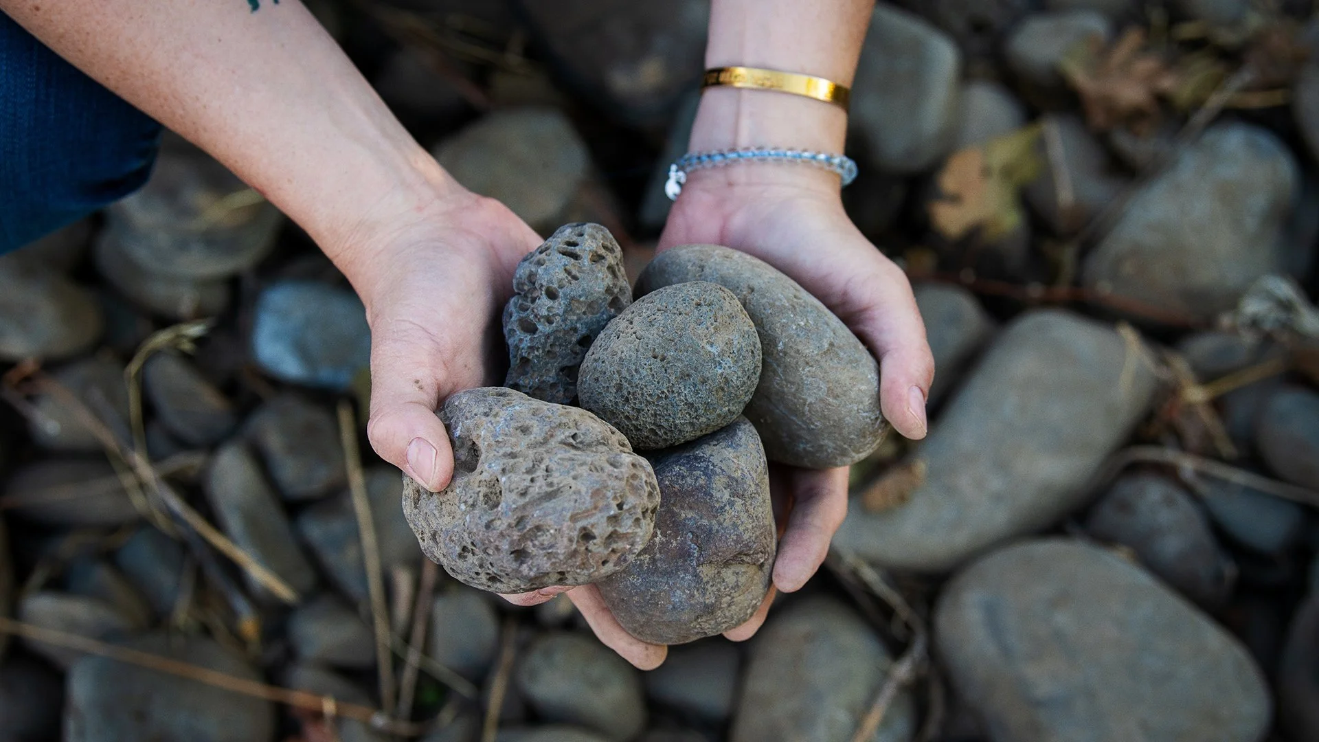 Hands holding large rocks