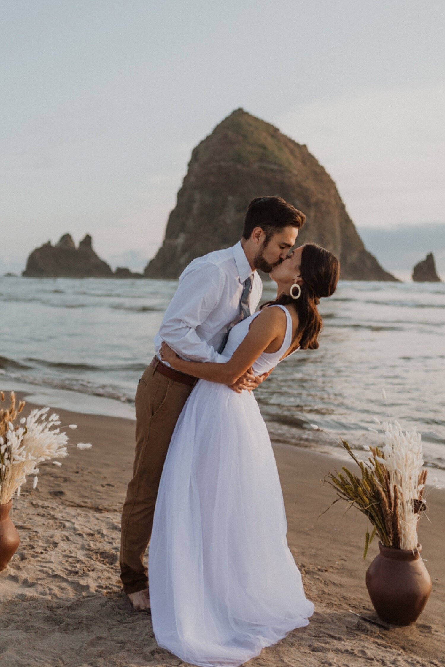 couple-kissing-beach-Oregon-coast-Elopement-ceremony-cannon.jpg