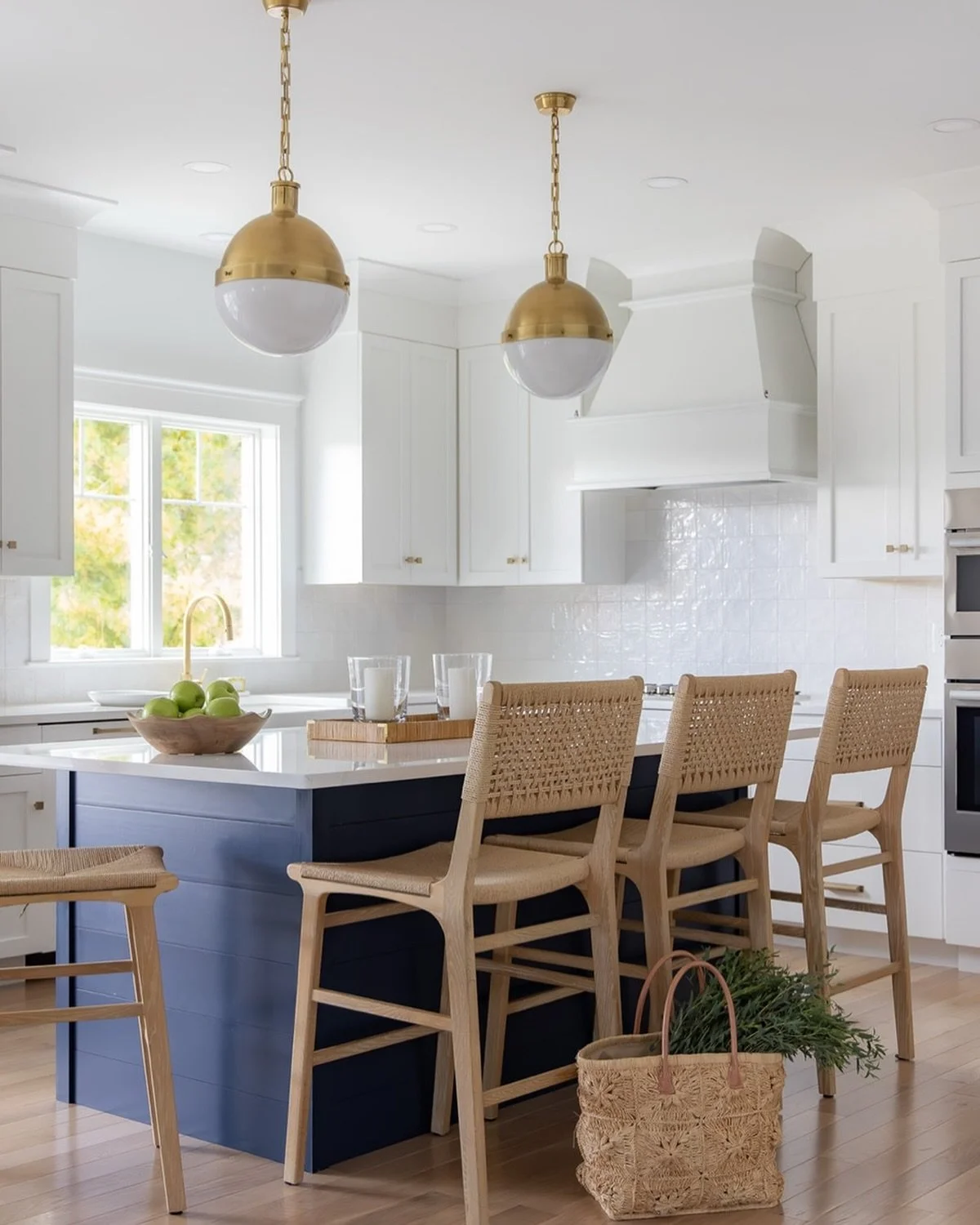 A recent project at Pine Hills, this bright and welcoming kitchen blends crisp white cabinetry, a deep navy island, woven textures, and warm brass accents for a coastal-refined feel.
Interior Design @Wendyhcallahan