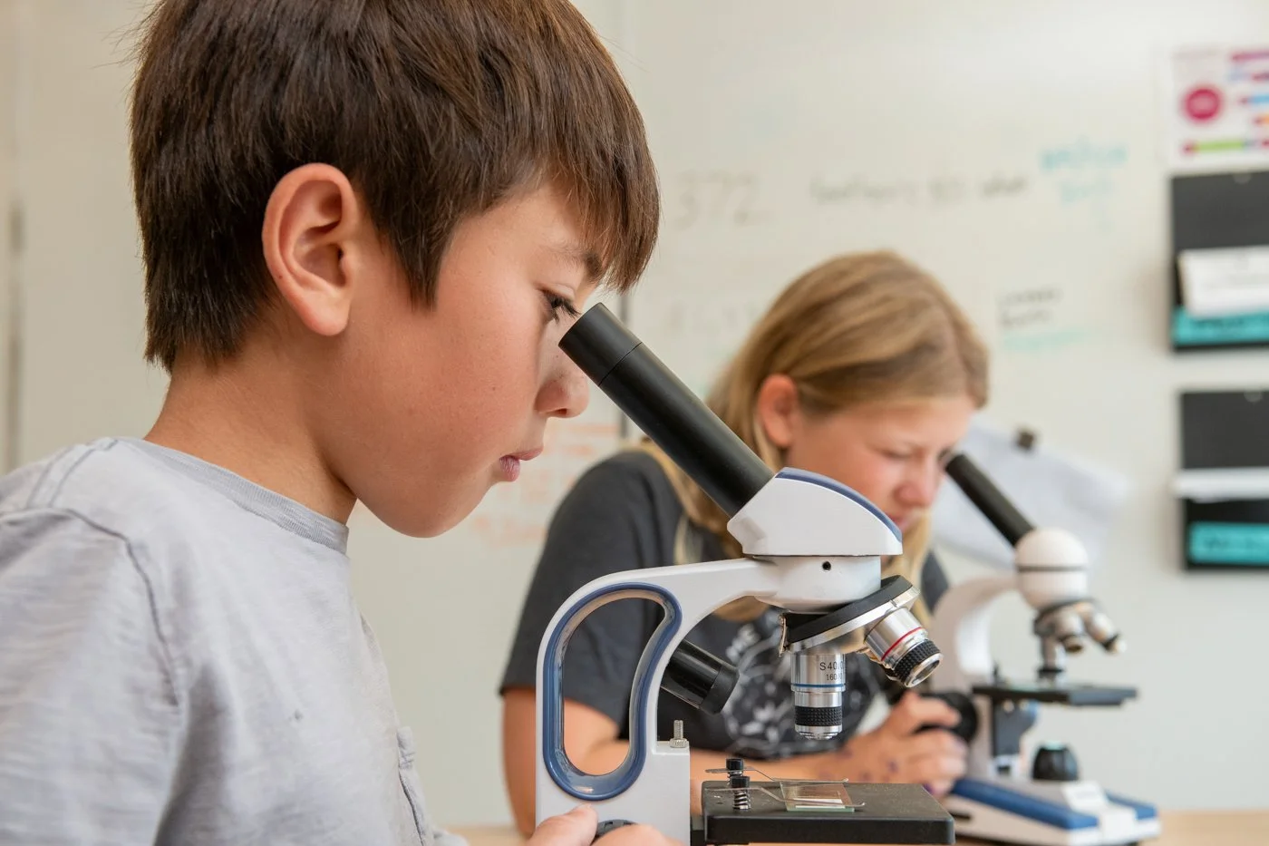 016-young-boy-looking-through-microscope-classroom-shots.jpg