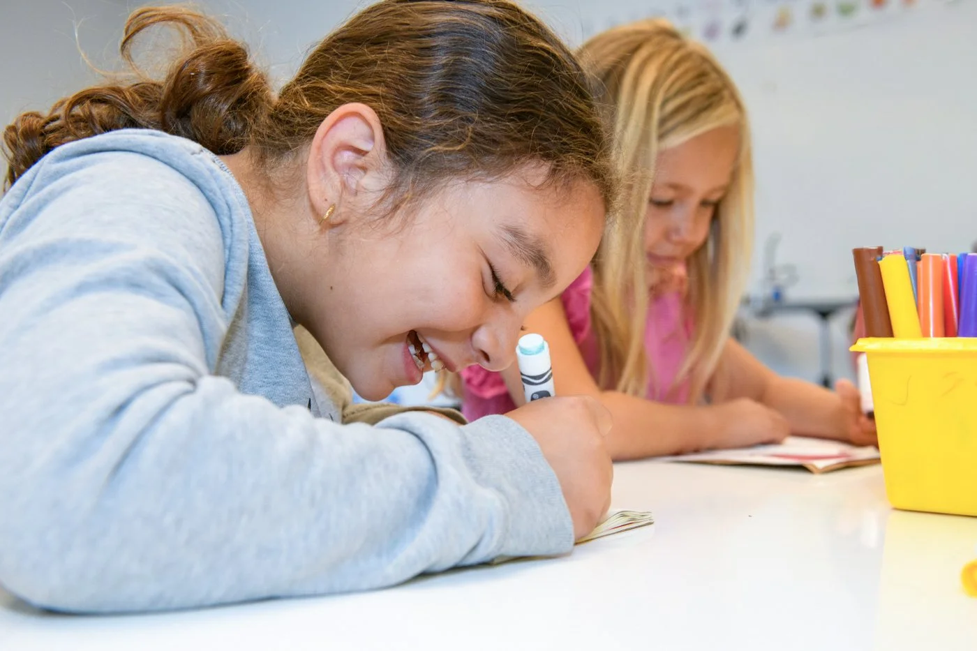 022-girl-smiling-while-writing-school-photographer.jpg