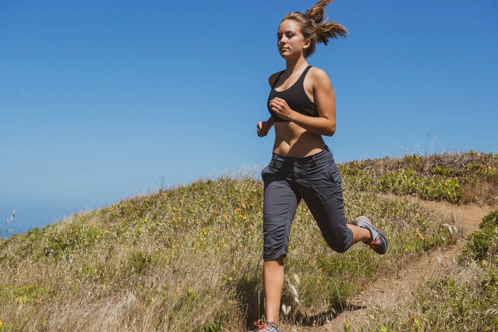 031-woman-running-downhill-lifestyle-portrait-session.jpg