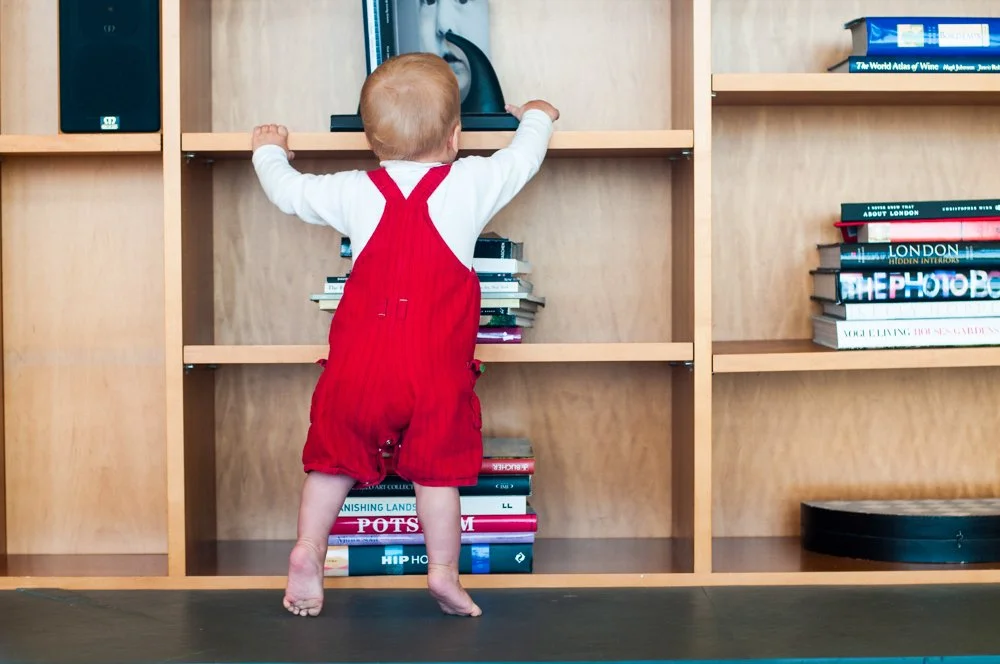 14-toddler-climbing-bookshelf-kids-photography-studio.jpg