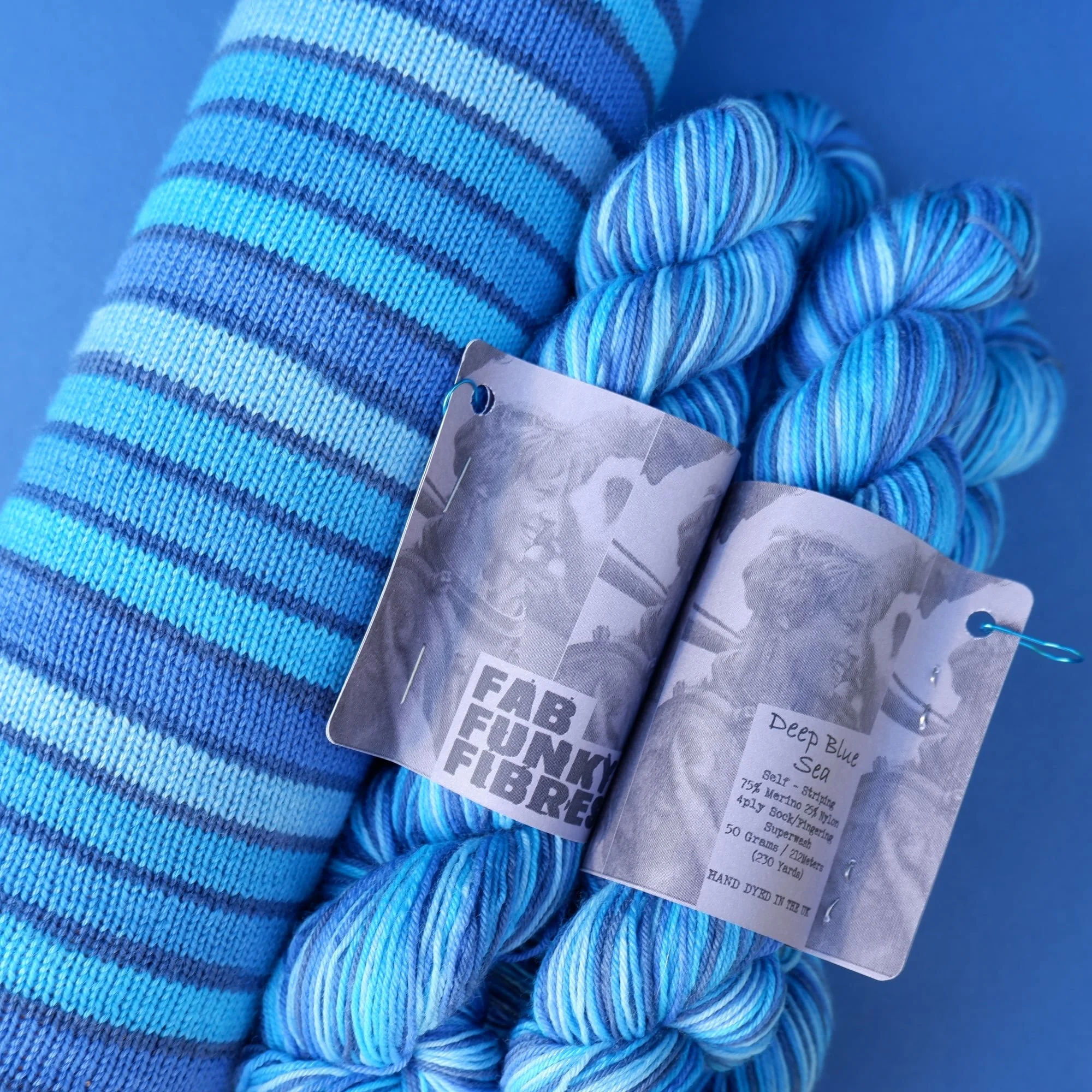 10 stripe hand dyed self-striping yarn cool shades of blue separated by a micro navy stripe
