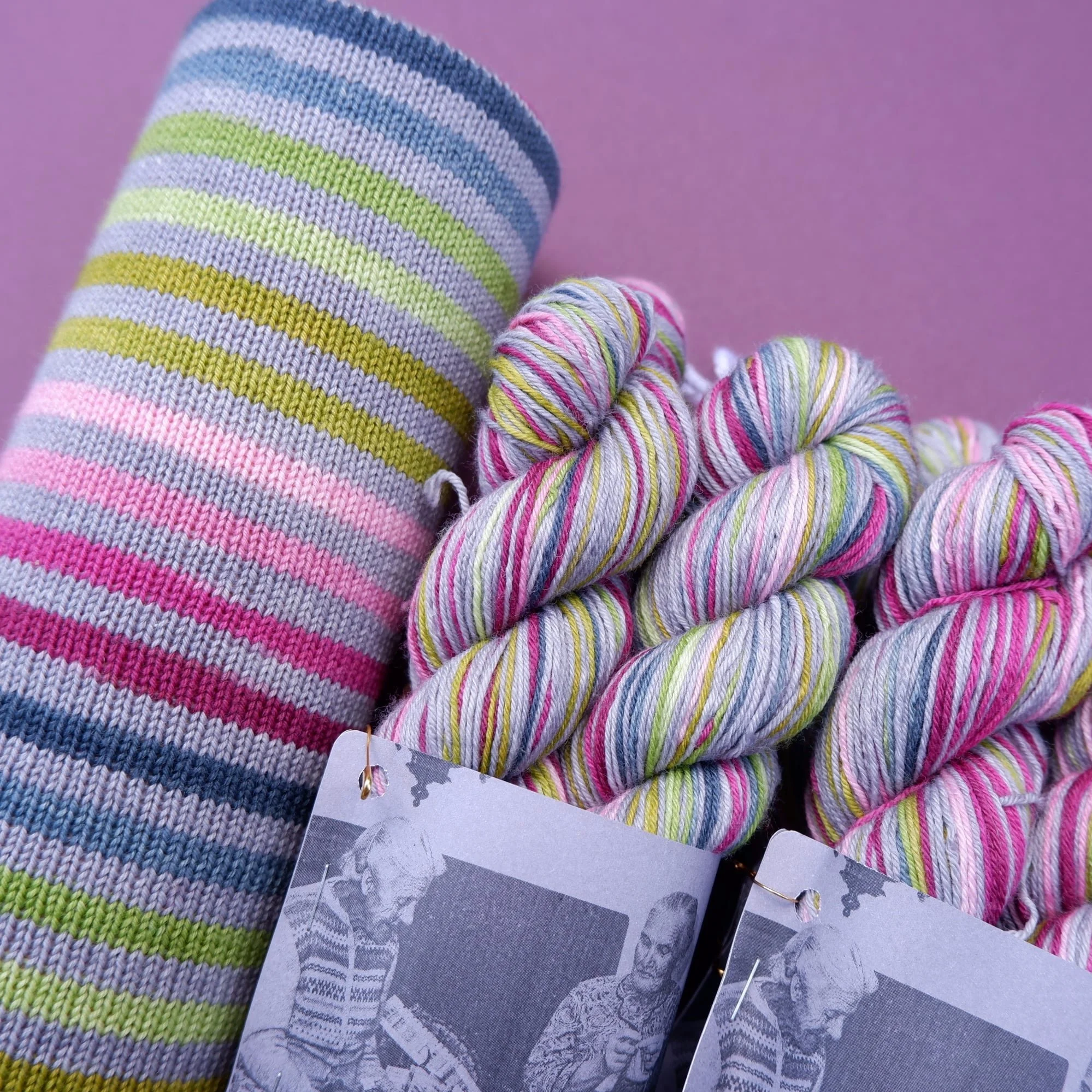 fab funky fibres hand dyed self striping yarn 20 stripes earthy greys muted blues and a pop of pink separated with a slate grey