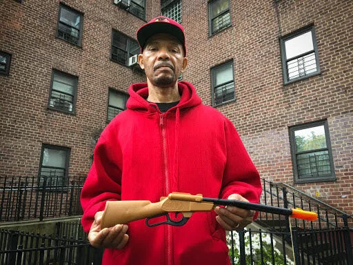 Nicholas Heyward Sr. holding the toy gun his son was holding when killed by police.