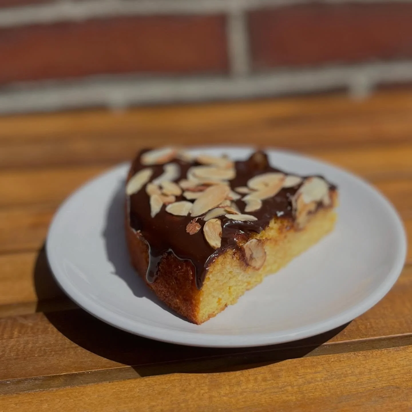 don&rsquo;t forget to stop in try our spring favorite ~ 

GF Orange Almond Cake!🍊🍫🍰
orange juice, pulp, and zest in the batter to make it extra moist and full of flavor. topped with chocolate ganache and toasted sliced almonds! available as our sp