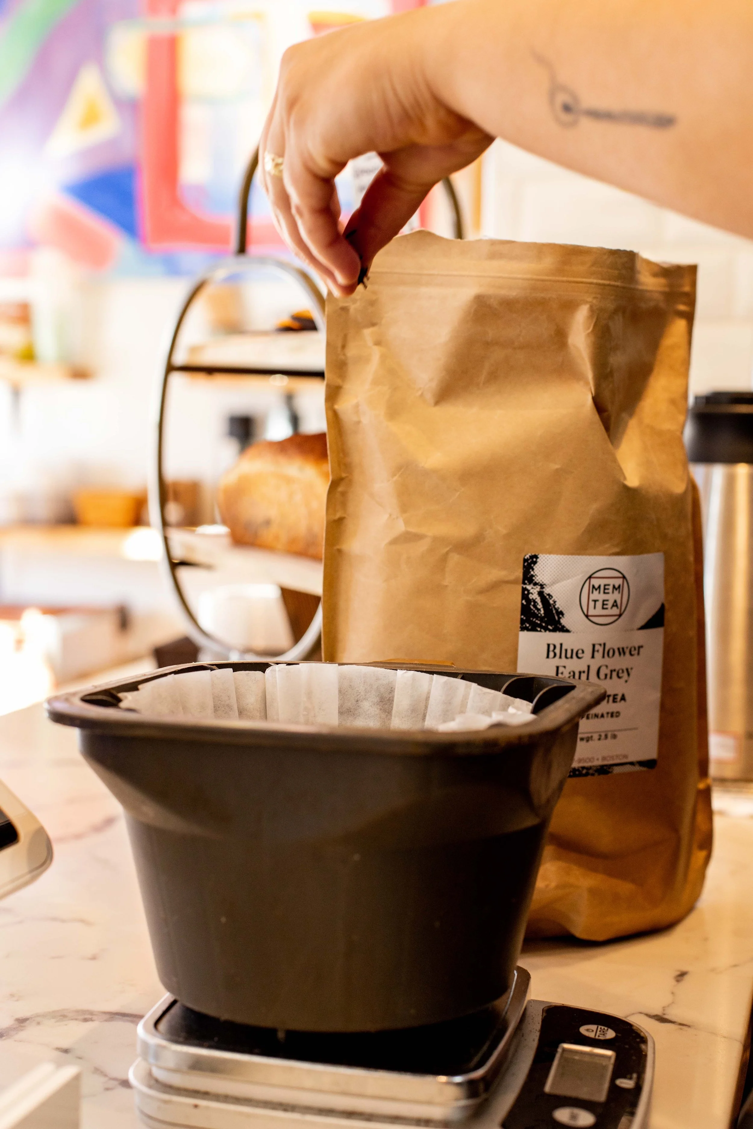 a barista weighing out tea leaves