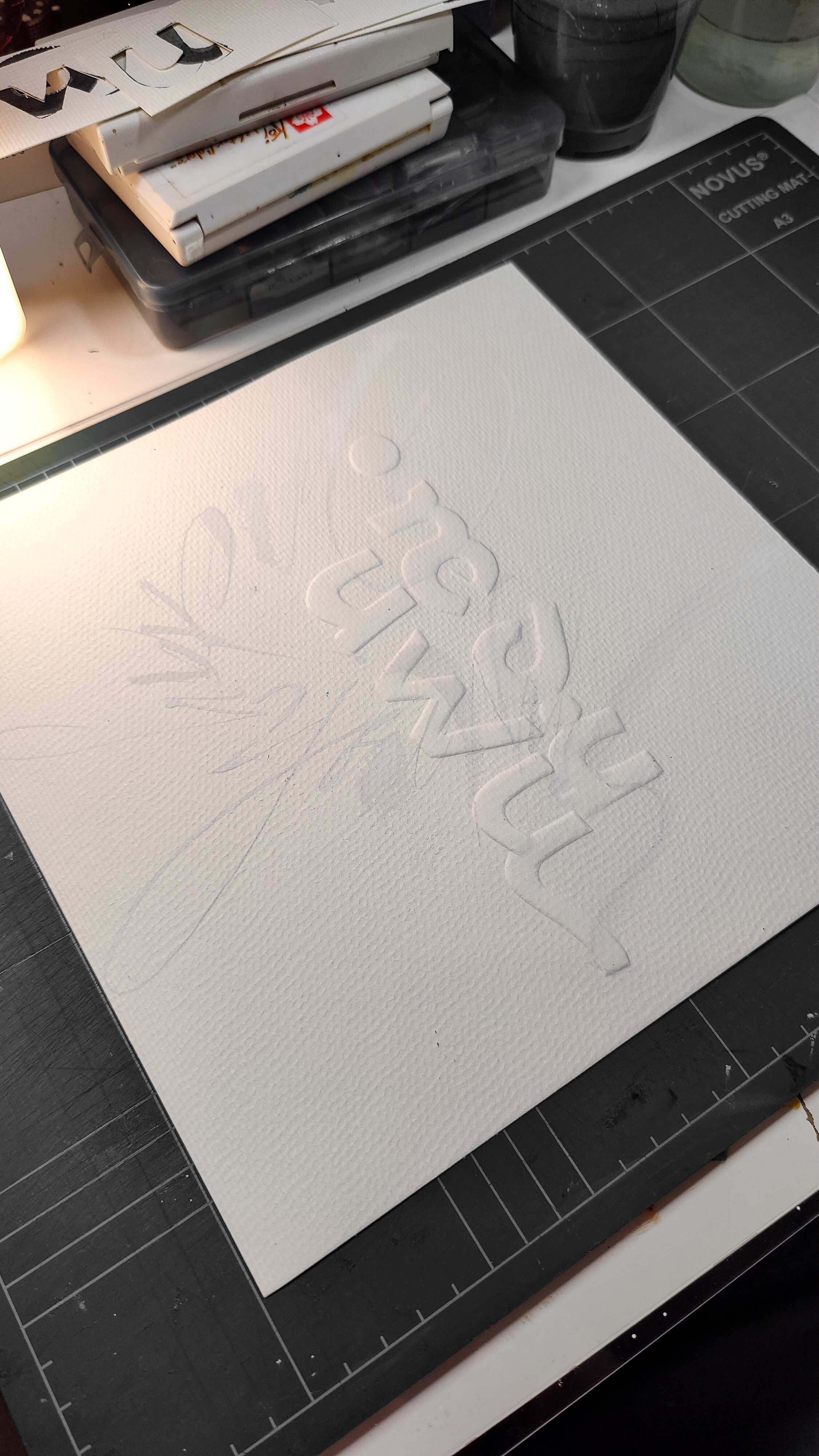 Process: Embossed letters form the second layer of text.