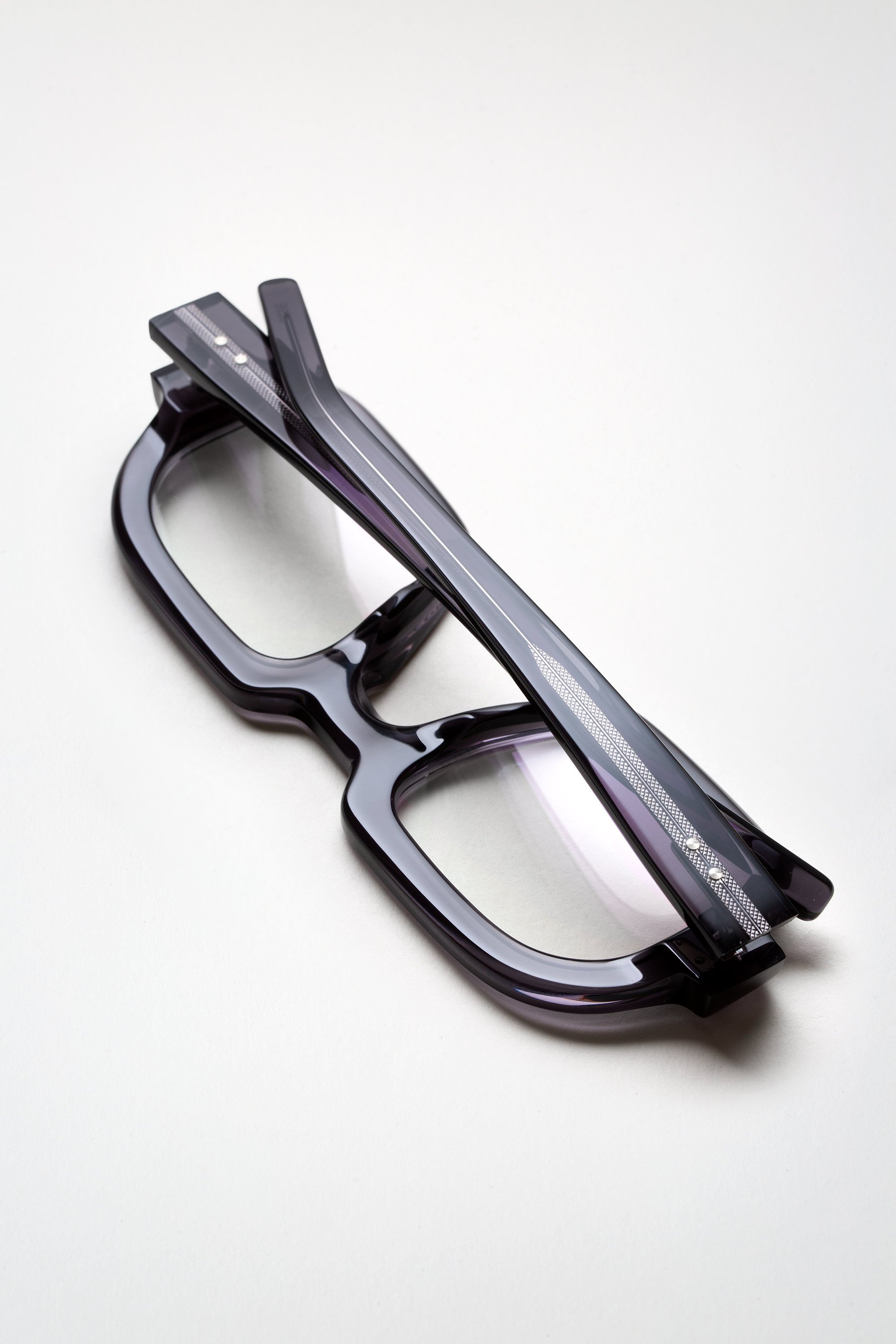 rudy-om6-eyeglasses-150-grey-6-temples-crossed-left.jpg