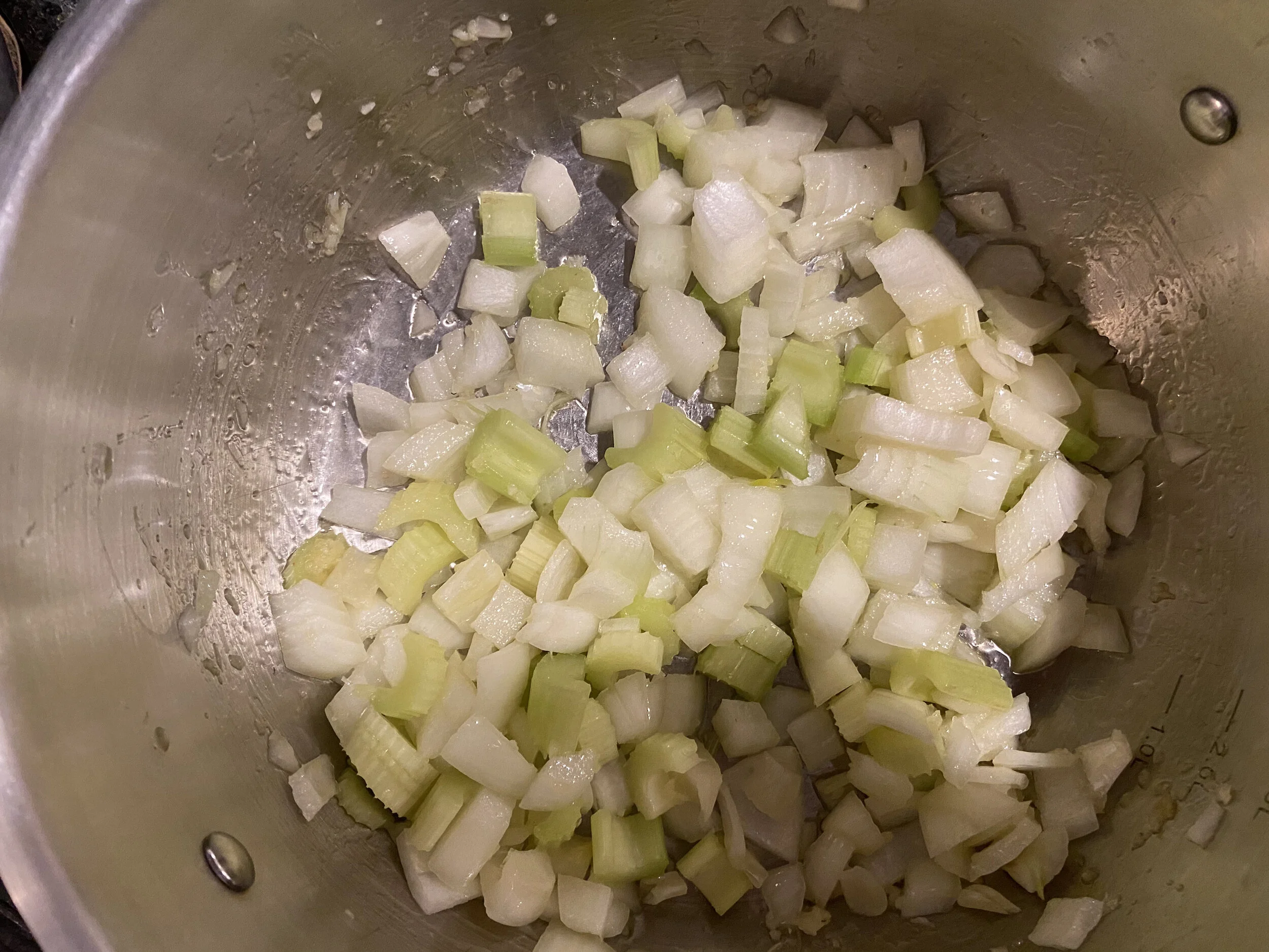 In a large soup pot heat up 1 tbsp of ghee; feel free to use butter or olive oil. Add garlic, celery and onions. Sauté until the onions are translucent.