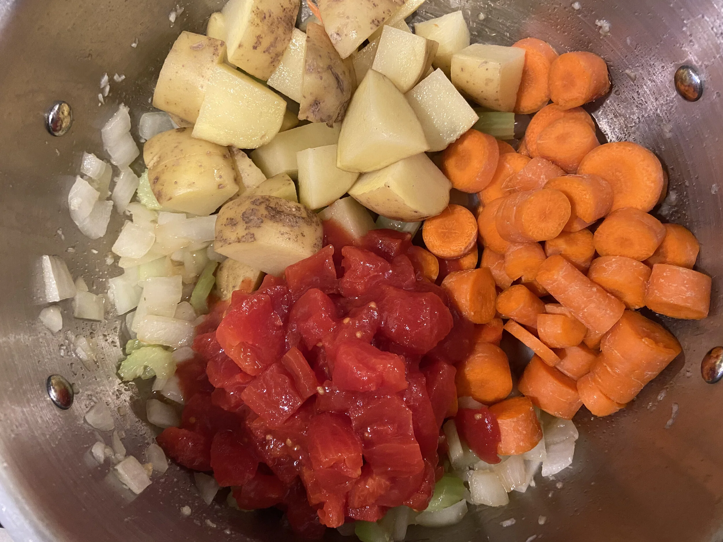Add in diced tomatoes, carrots, potatoes and any other veggies you’d like; mix.