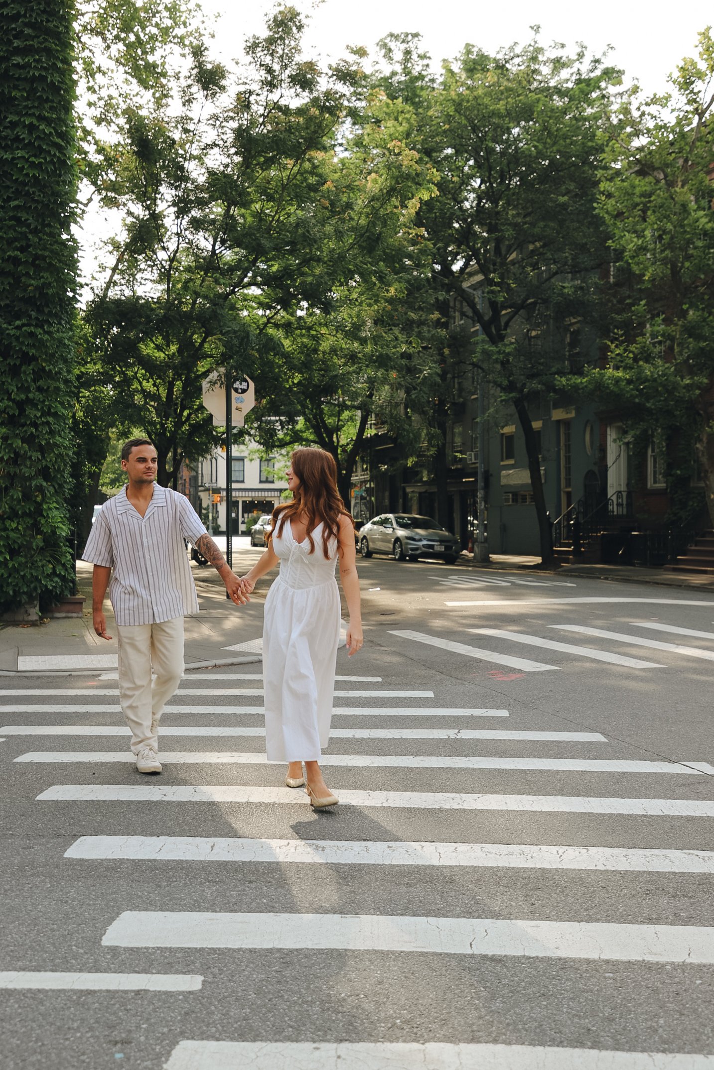 Couple walking hand-in-hand through the charming streets of West Village, NYC.