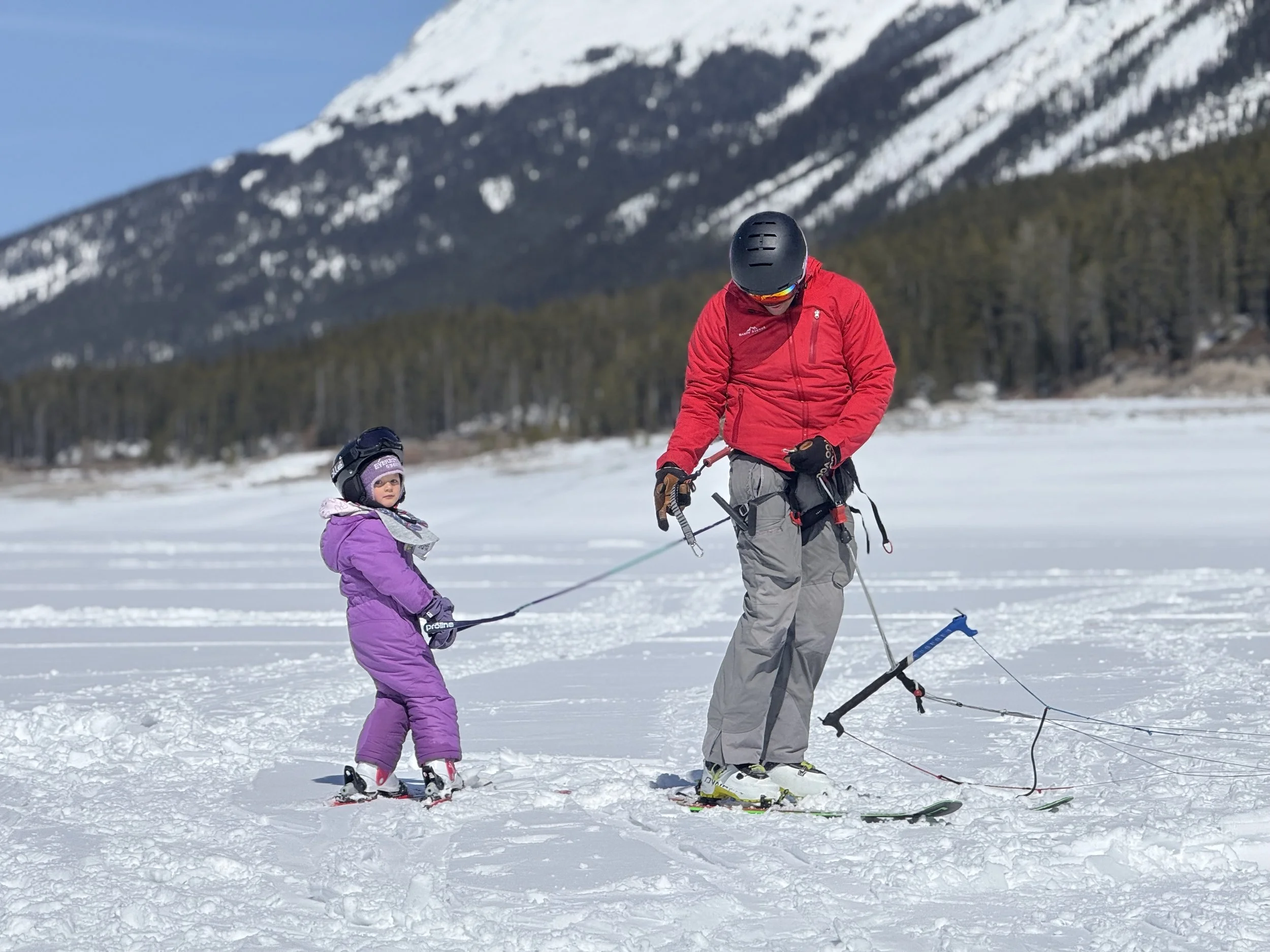 Dad and Daughter snow kite towing . Spray Lakes Alberta.

