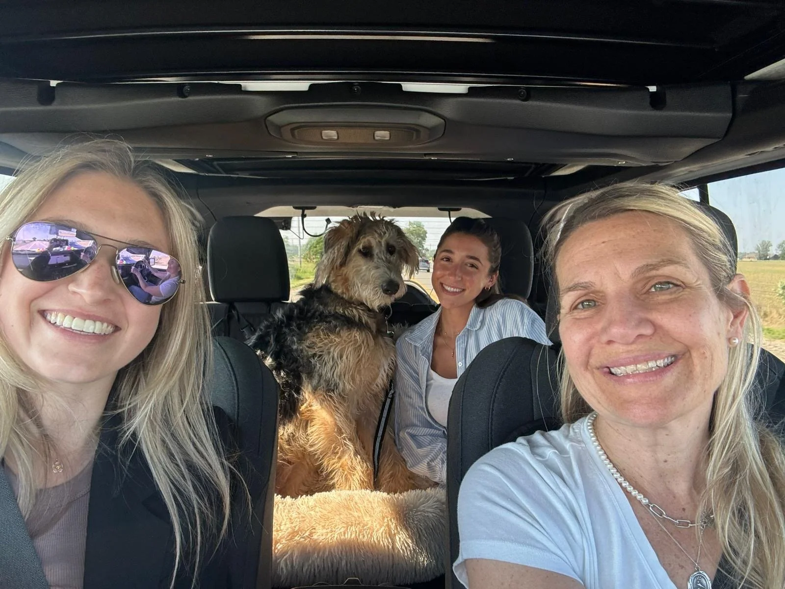 The Peace of Mind CBT team taking a selfie in a car with River their Therapy Dog.