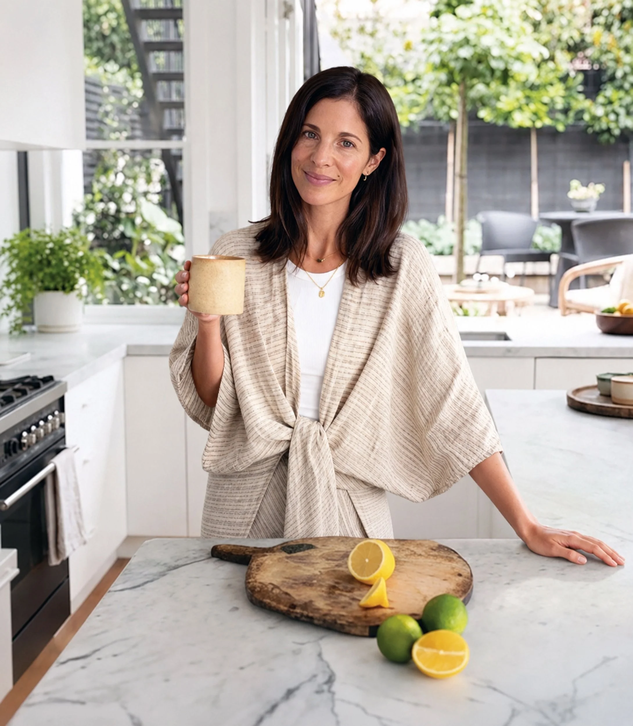 Kate Lillian Burford at home in Christchurch with a warm drink and fresh citrus