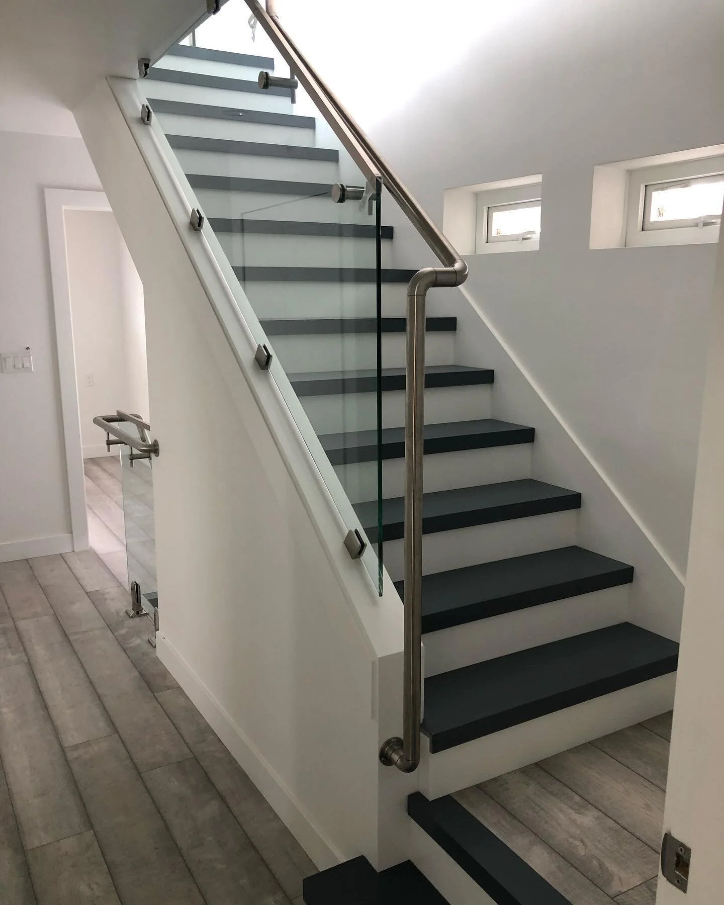 In-house custom staircase finished with steel &amp; glass railings #carpentry #builder #vancouver #railings #staircase