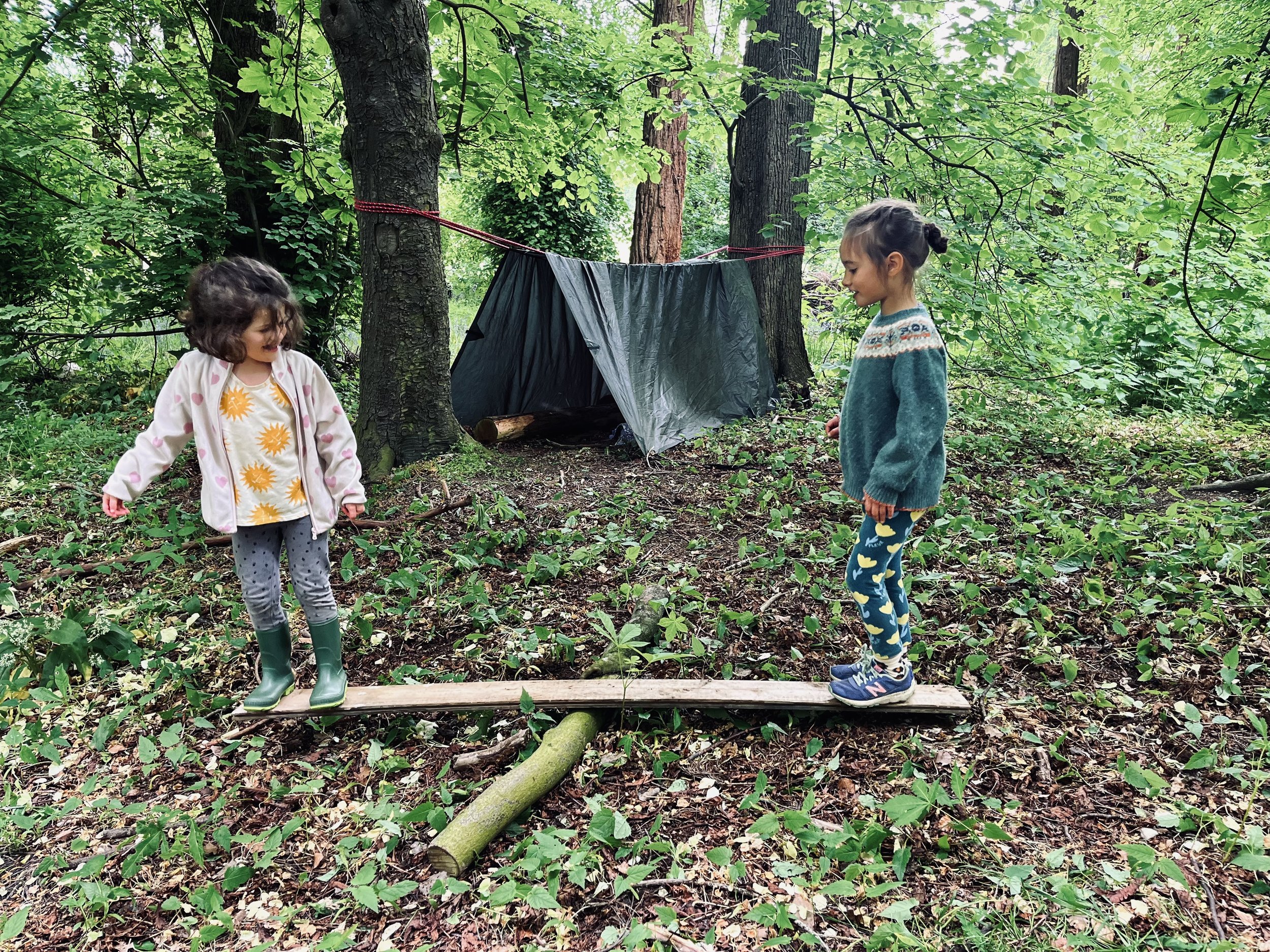 Girls balancing on plank at Wild Things pre school We Are Wild - Darlington