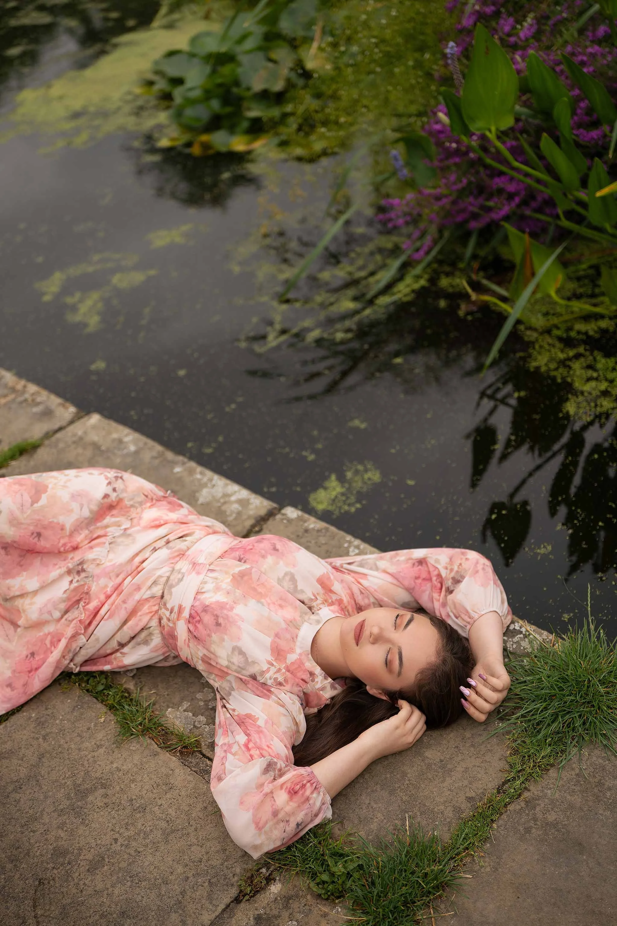 Peaceful outdoor portrait by the pond at Canons Park, featuring soft florals, natural greenery, and a calm summer atmosphere.