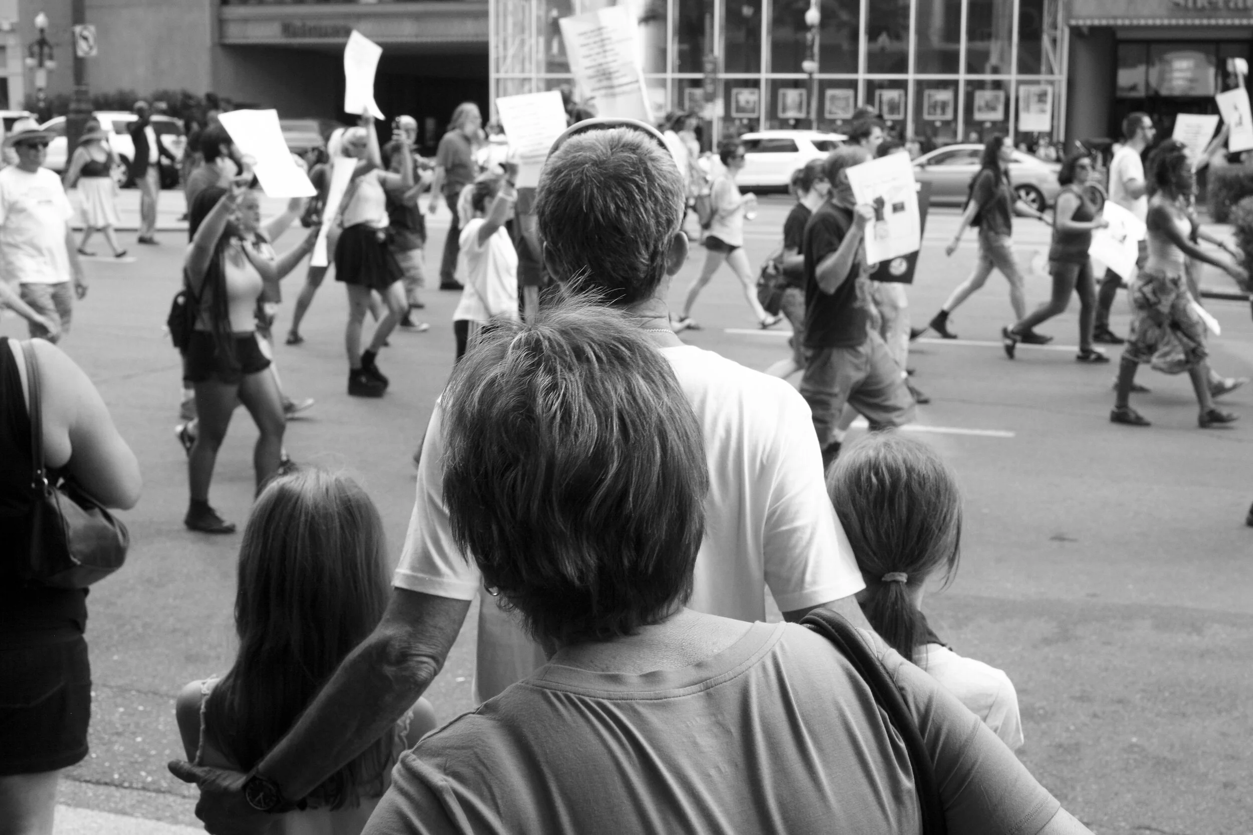 Family of tourists on Canal Street witnessing a protest to remove symbols of white supremacy