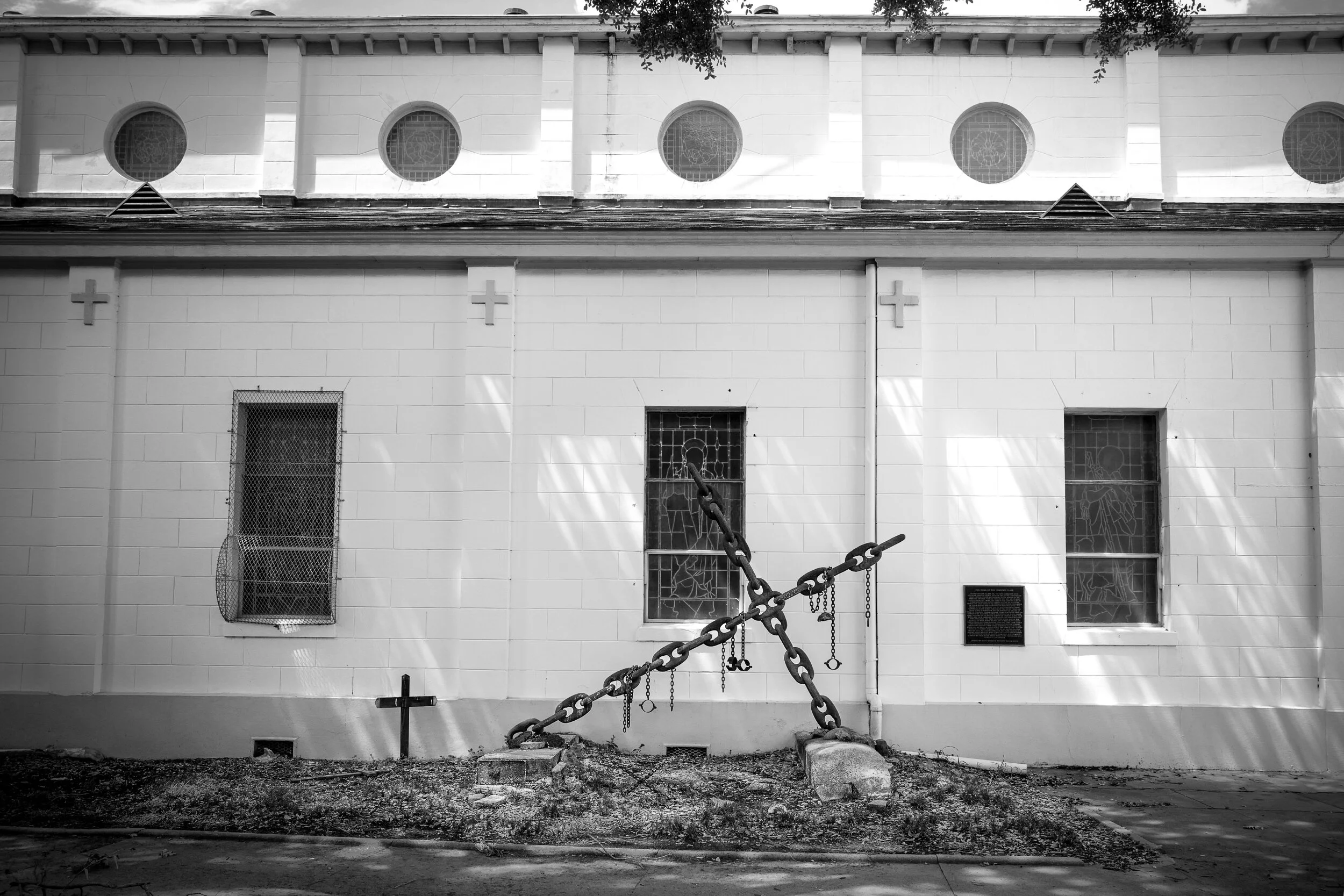 "Tomb of the Unknow Slave" in Treme on the side of St Augustine Church. "15 hundred pound chain cross, draped with shackles, plaque dedicated to the nameless, faceless slaves who met an untimely death in the Treme, as well as others buried throughout