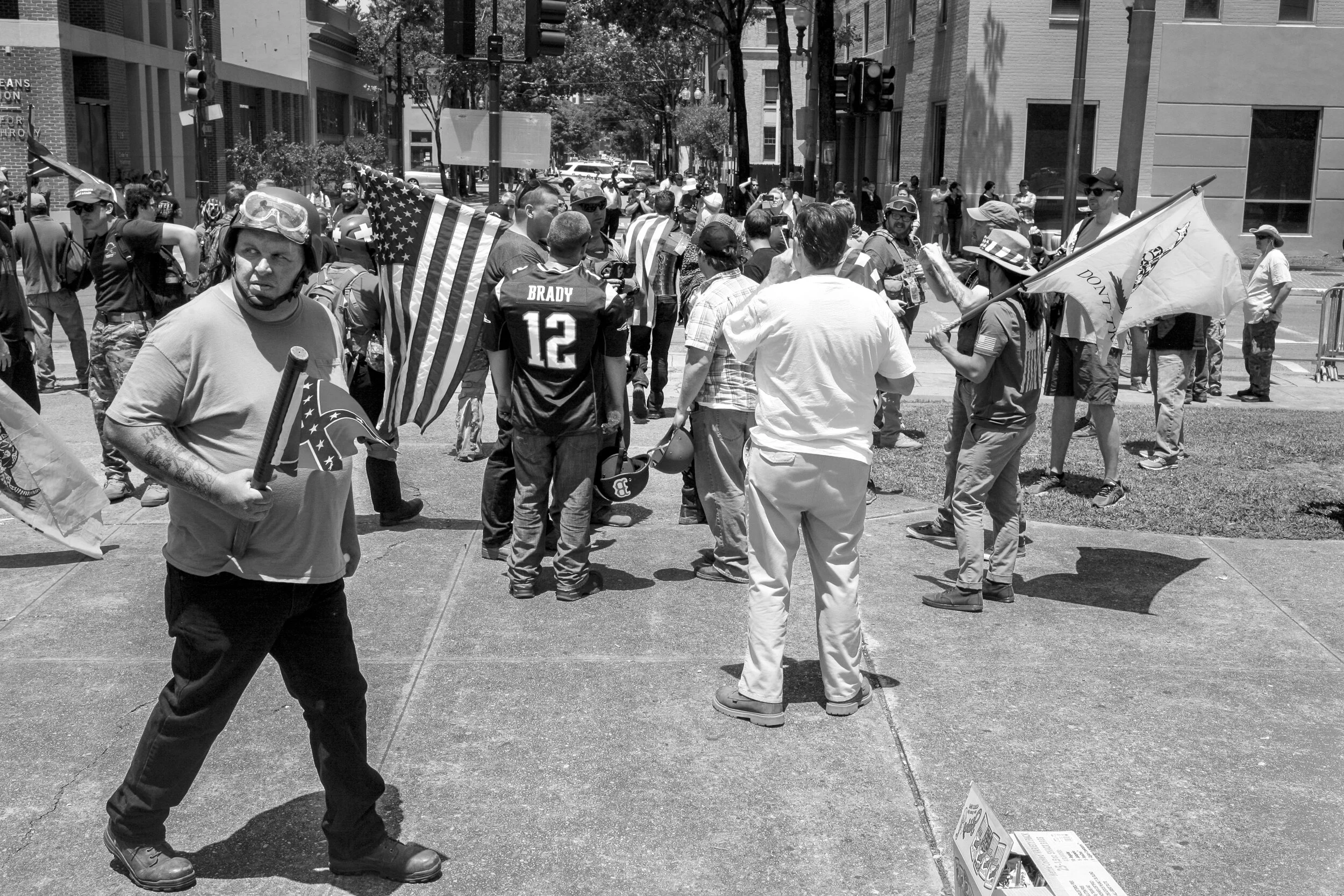 Various white supremacist groups rallying at Lee Circle, (left foreground) man with KKK tattoo wielding a club with a Confederate flag attached 