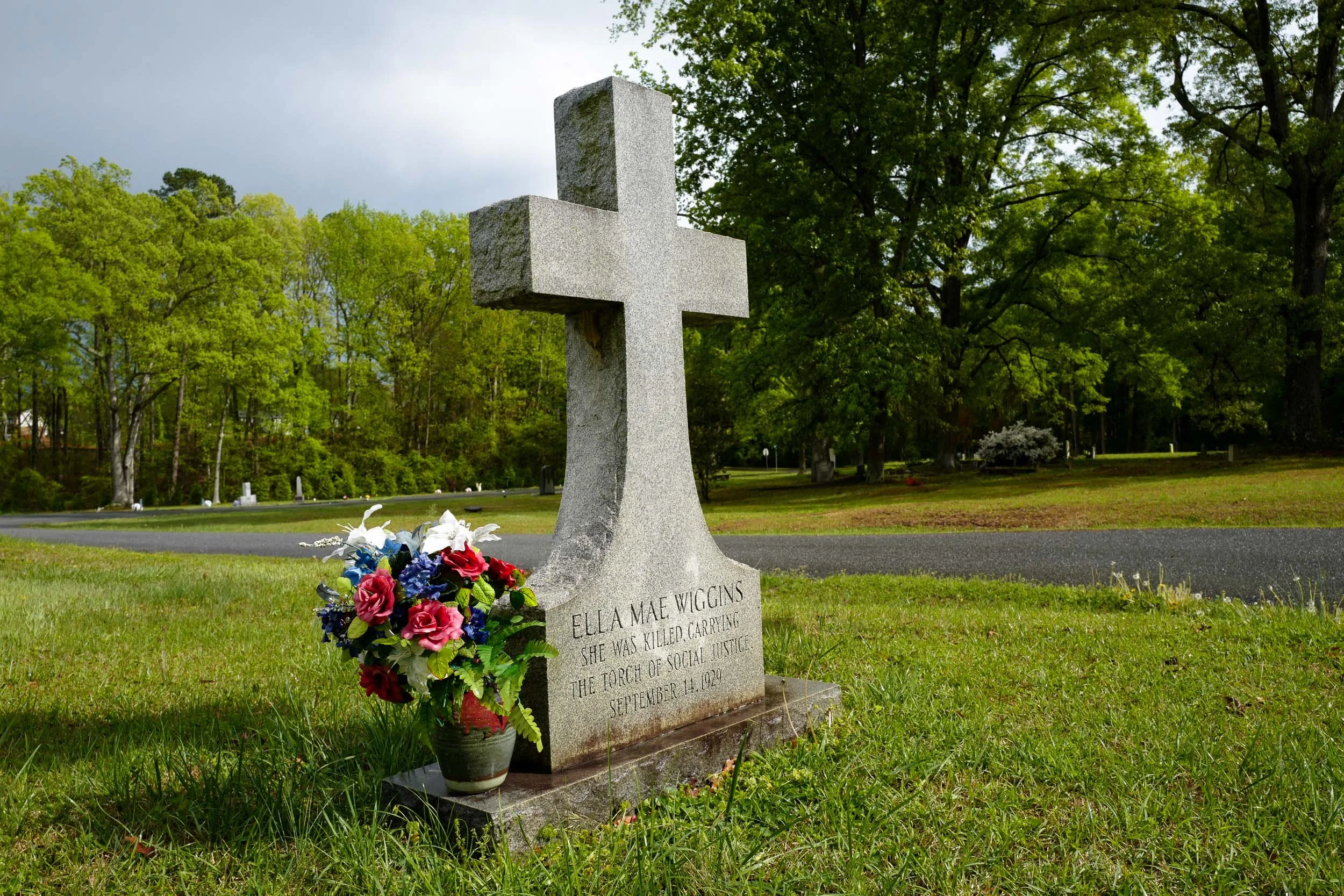 1929 Loray Mill Strike—Headstone of slain strike balladeer Ella Mae Wiggins: “SHE WAS KILLED, CARRYING THE TORCH OF SOCIAL JUSTICE.”  The pregnant single mother who was murdered during Gastonia's infamous strike, leaving five children orphaned, was a