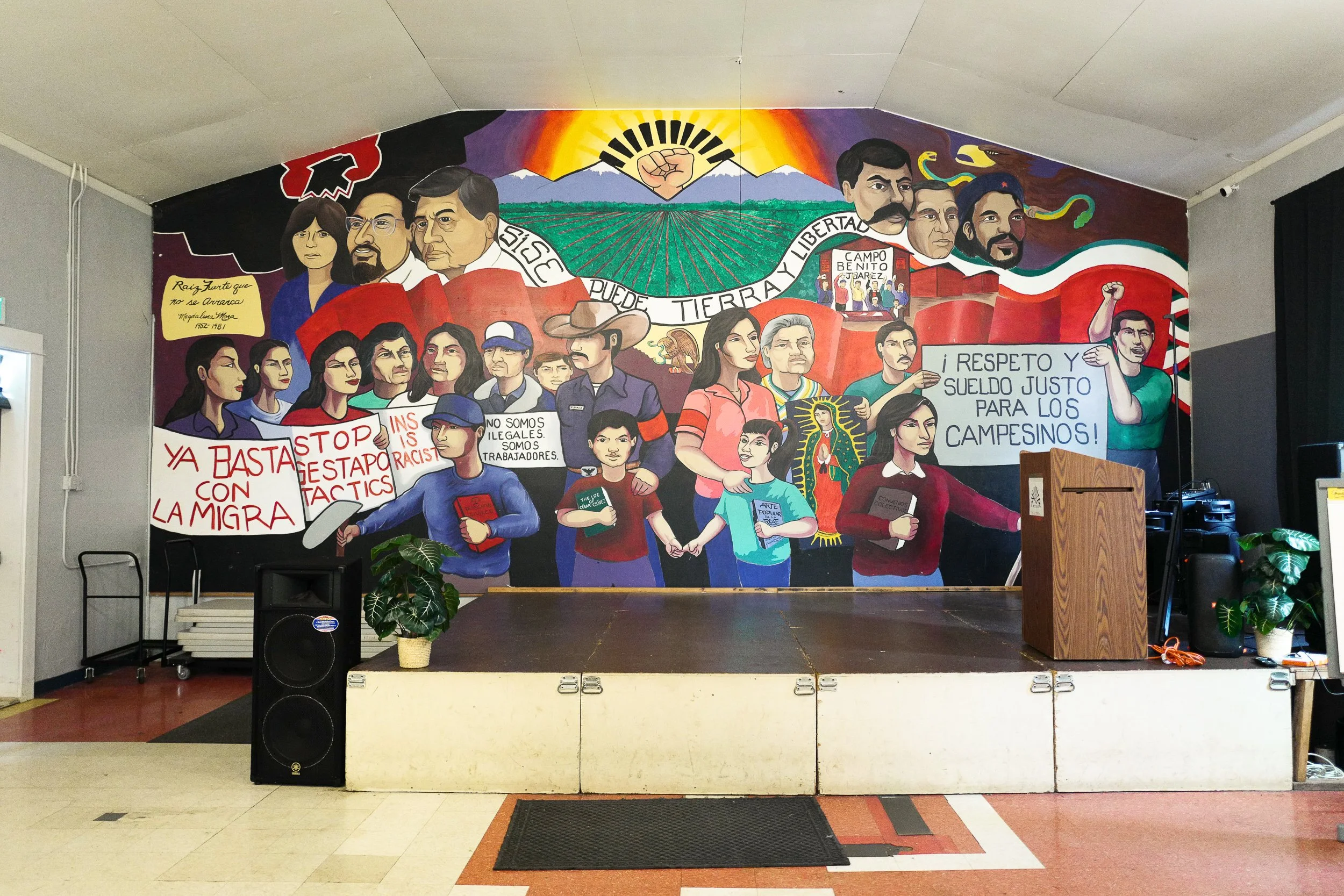 Pineros Y Campesinos Unidos del Noroeste—The mural behind the speakers podium at PCUN's headquarters illustrates the forty year history of the farm worker union, as well as the cultural heritage and political struggles of its largely Mexican immigran