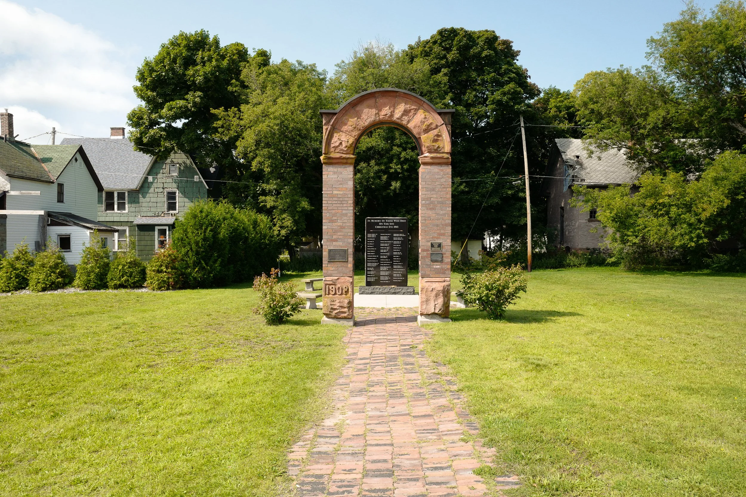 1913 Italian Hall Disaster—Reconstructed entrance arch at Italian Hall Memorial Park. In 1913, 73 people—59 of them children—were killed in a stampede at a striking miners’ Christmas party after an anti-union agent falsely cried “Fire!” (Calumet, MI)