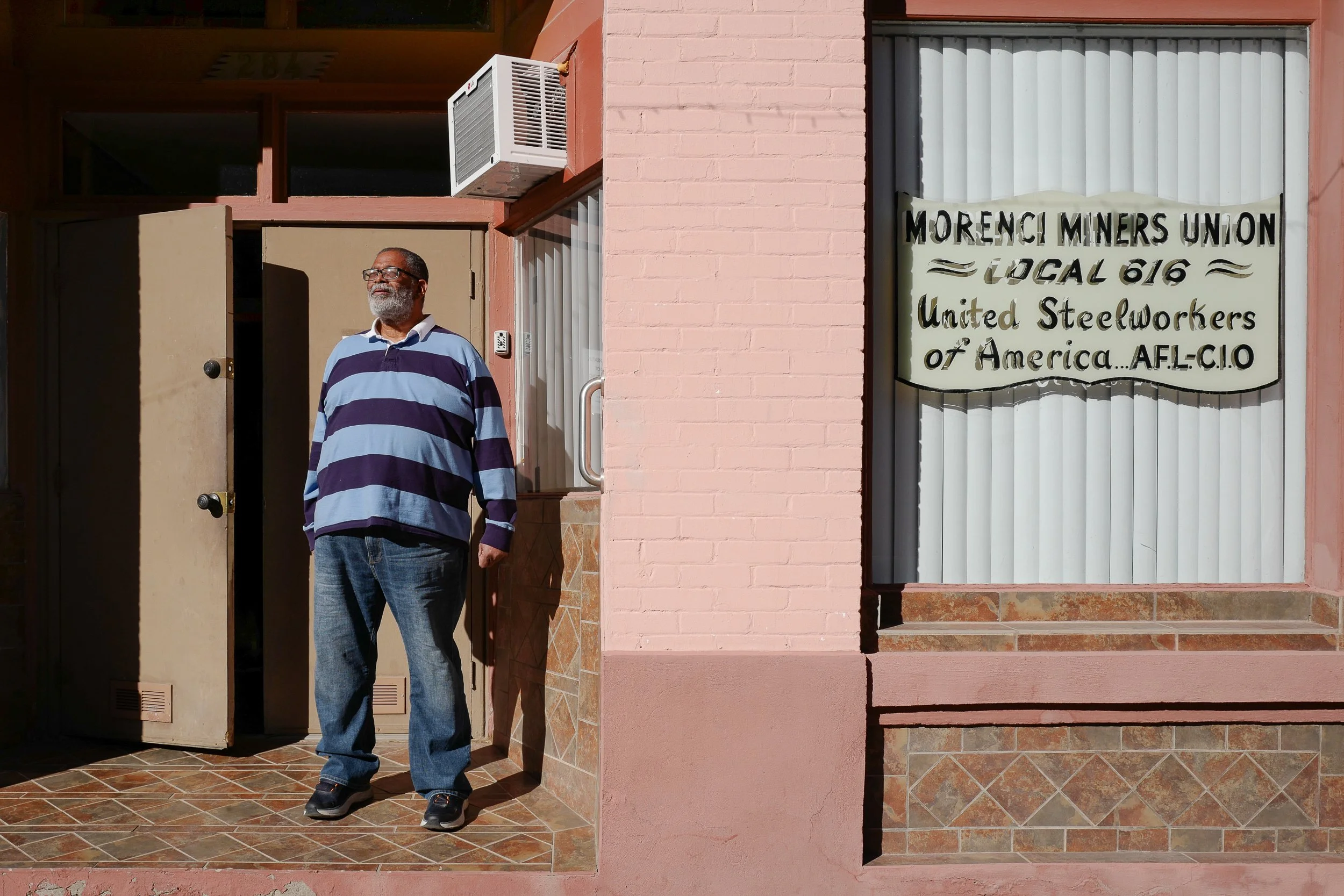 1983 Arizona Copper Mine Strike—Jeff Gaskin stands before the former Morenci Miners Union Hall. Emboldened by Reagan-era policies, Phelps-Dodge crushed the local United Steelworkers union, setting a national union-busting precedent. Gaskin transforme