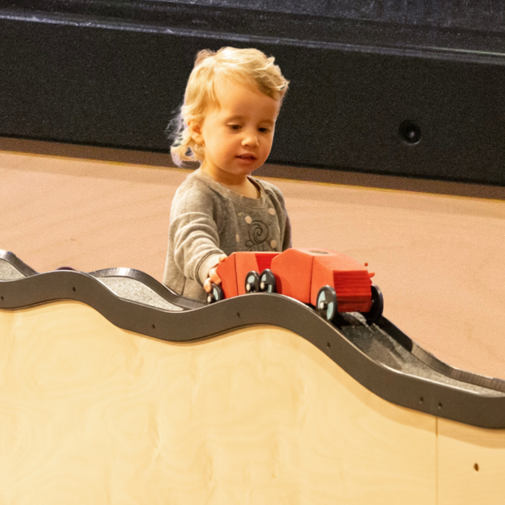 Child playing and exploring in On Track: Engineering in Motion