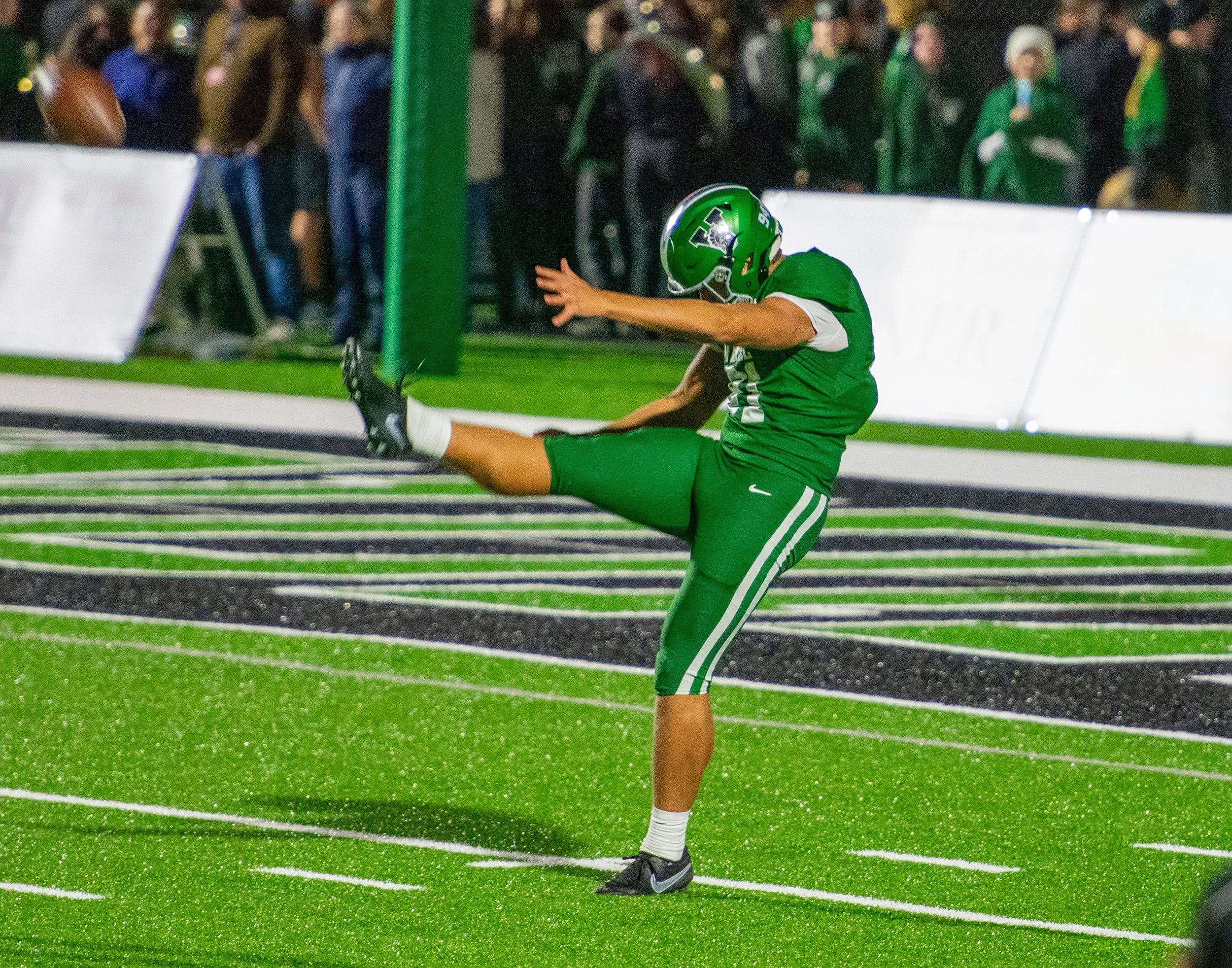 Original reference photograph capturing Reynolds mid-punt during the Venice vs. Sumner High playoff game. Shot with a Nikon D3400 and 70-200mm f/2.8 lens from the sideline.