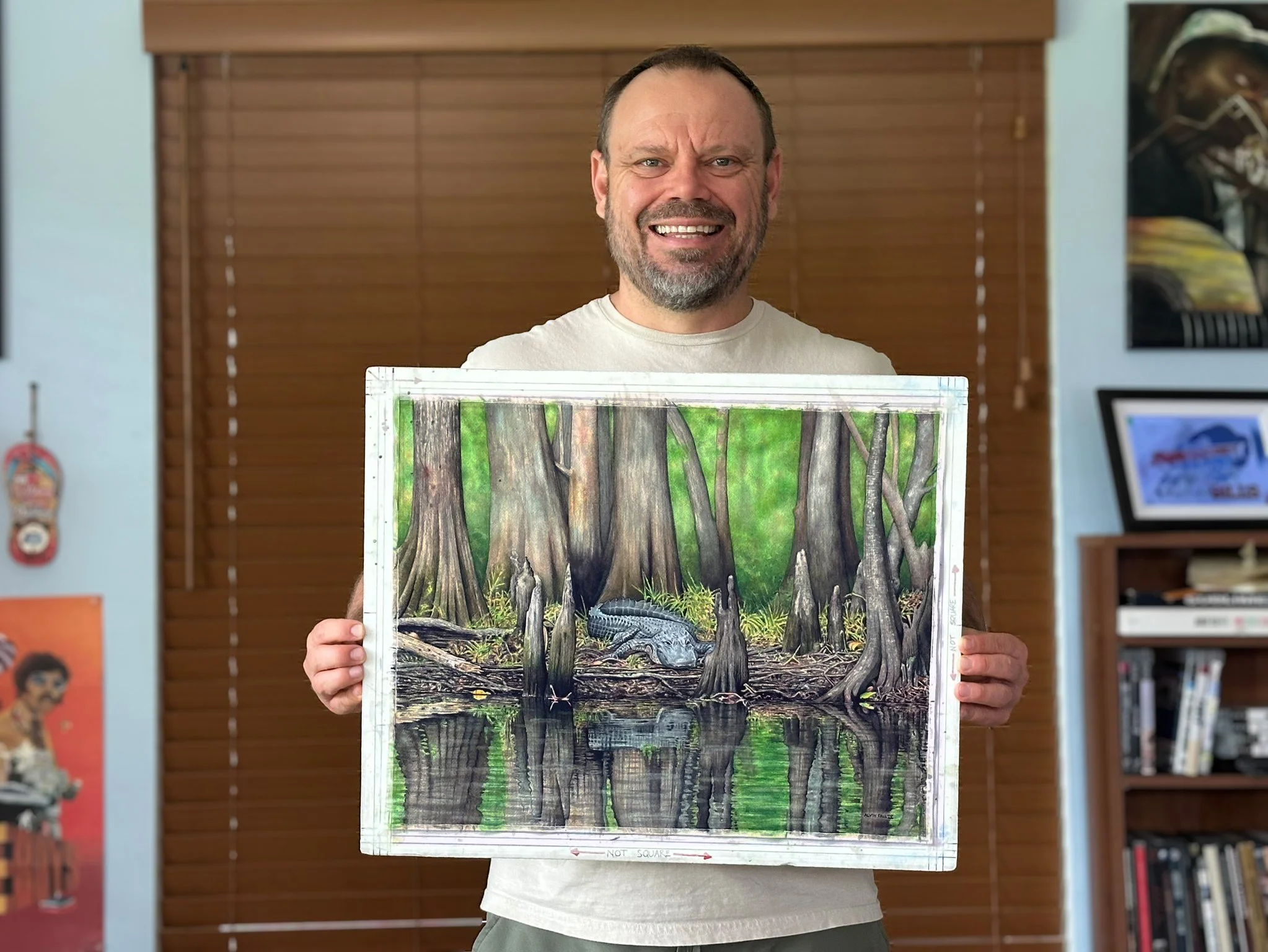 Alvin Fall IV with the completed Tourist Trap watercolor in his Sarasota studio.