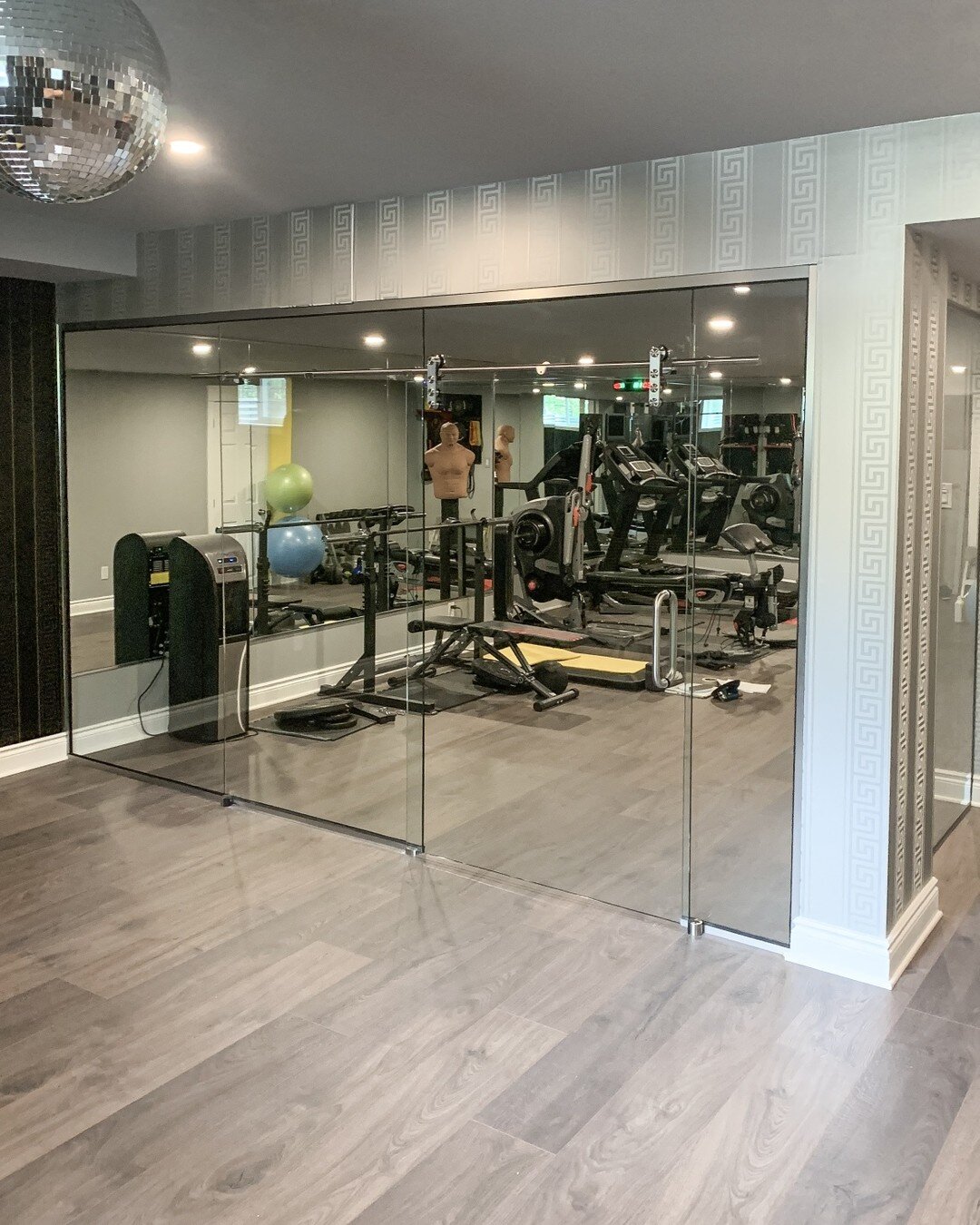 Glass wall and mirrors installed for this basement gym 👍