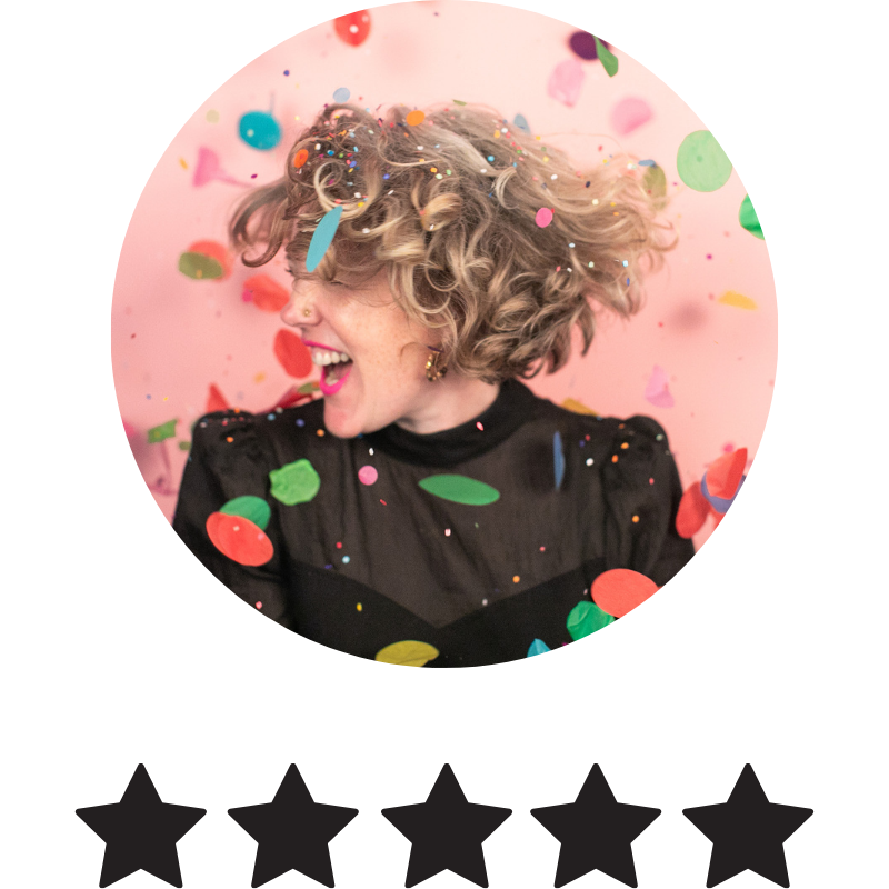 A woman with curly blonde hair smiling and looking to the side, surrounded by colorful confetti and pink background, celebrating joy and happiness.