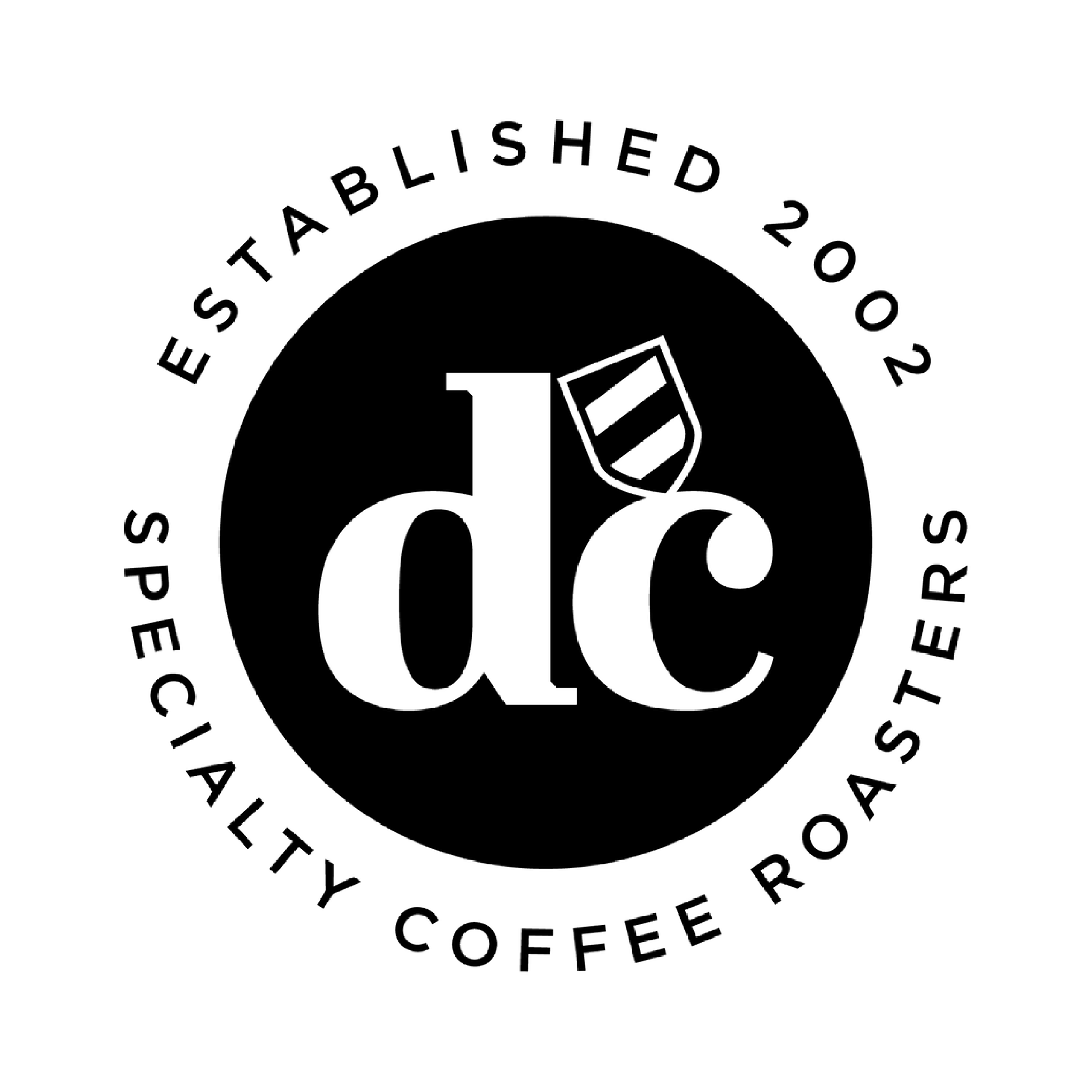 Circular logo with large stylized letters 'a' and 'c' and a small coffee cup illustration, encircled by the text 'Established 2012 Specially Coffee Roasters'.