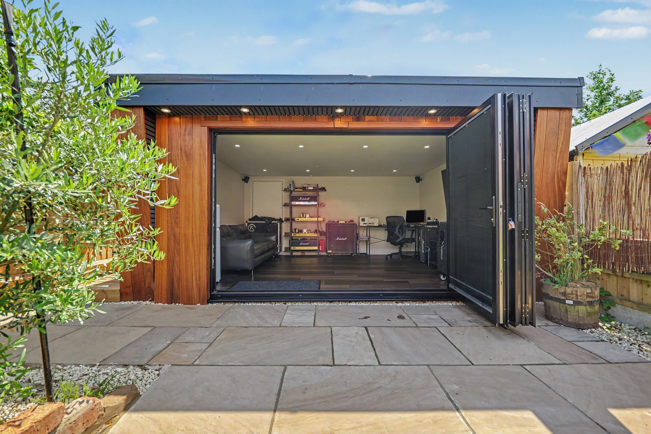 Completed bespoke cedar-clad garden room by In House–Out House