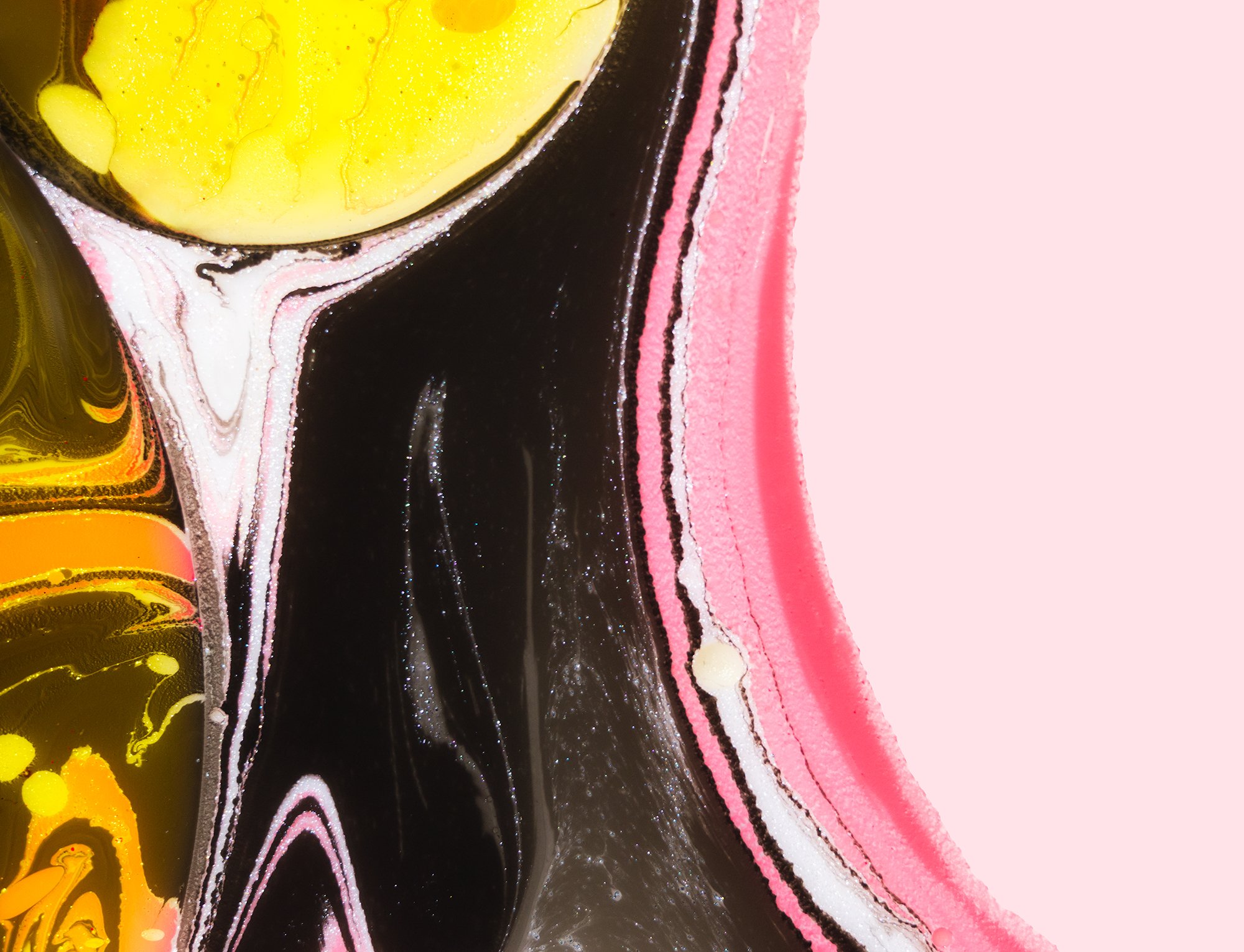 Close-up of an abstract fluid art painting with black, yellow, pink, and white swirling patterns and textures.