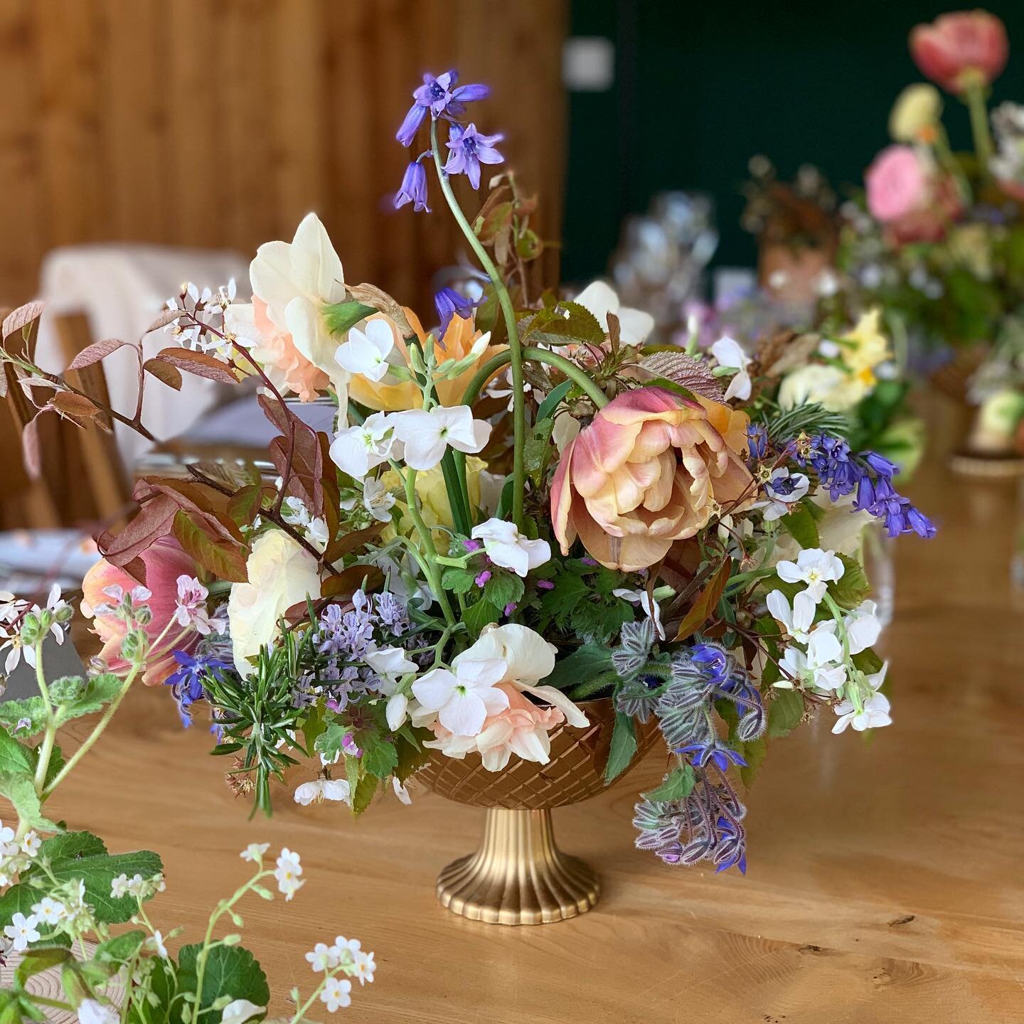 A joyful celebration of Spring for the tables for M &amp; A&rsquo;s wedding meal, each arrangement an expression of this moment in the seasonal flowery year. 
Tulips, narcissus, stocks, borage, bluebells, blossom and ranunculus brought gorgeous colou