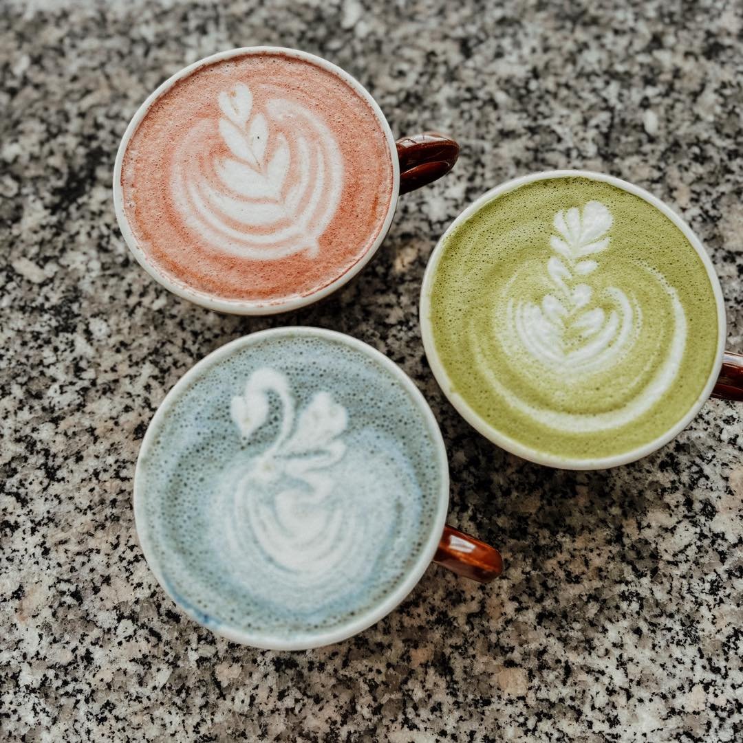 🌸🍵 Spring has sprung at our caf&eacute;! 🌱 
Dive into the vibrant hues of our superfood lattes - now available with coconut milk! Indulge in the rich flavors of beetroot, the earthy goodness of matcha, or the floral essence of blue lavender. 
Embr