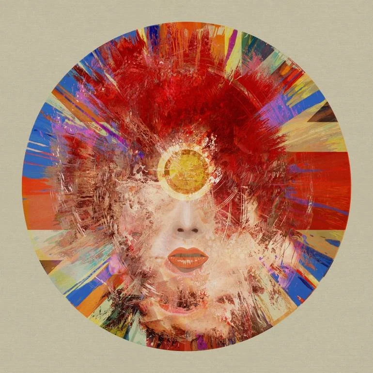 Abstract circular artwork featuring the face of a woman with vibrant red, orange, blue, yellow, and purple paint splashes surrounding her head, with her mouth slightly open and lips painted red, and a yellow circle on her forehead.