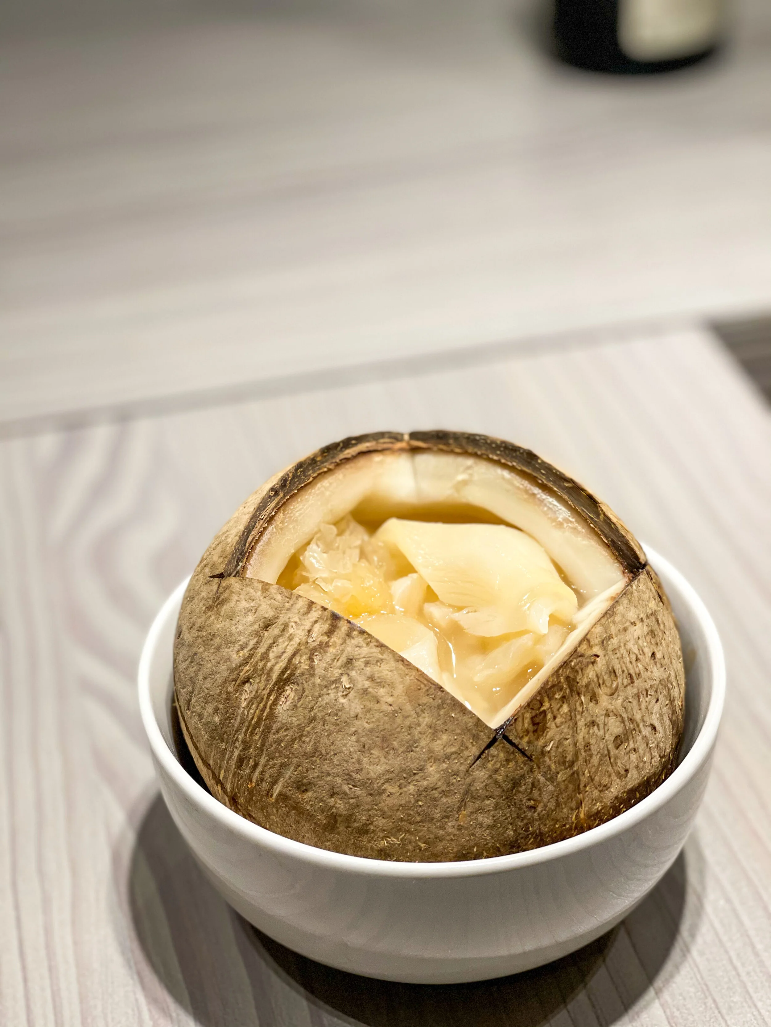 Traditional Slow-Cooked Chicken Soup with Fish Maws and Dried Scallops,&nbsp;in a Whole Coconut 原盅椰子炖花胶瑶柱鸡汤 £40&nbsp;