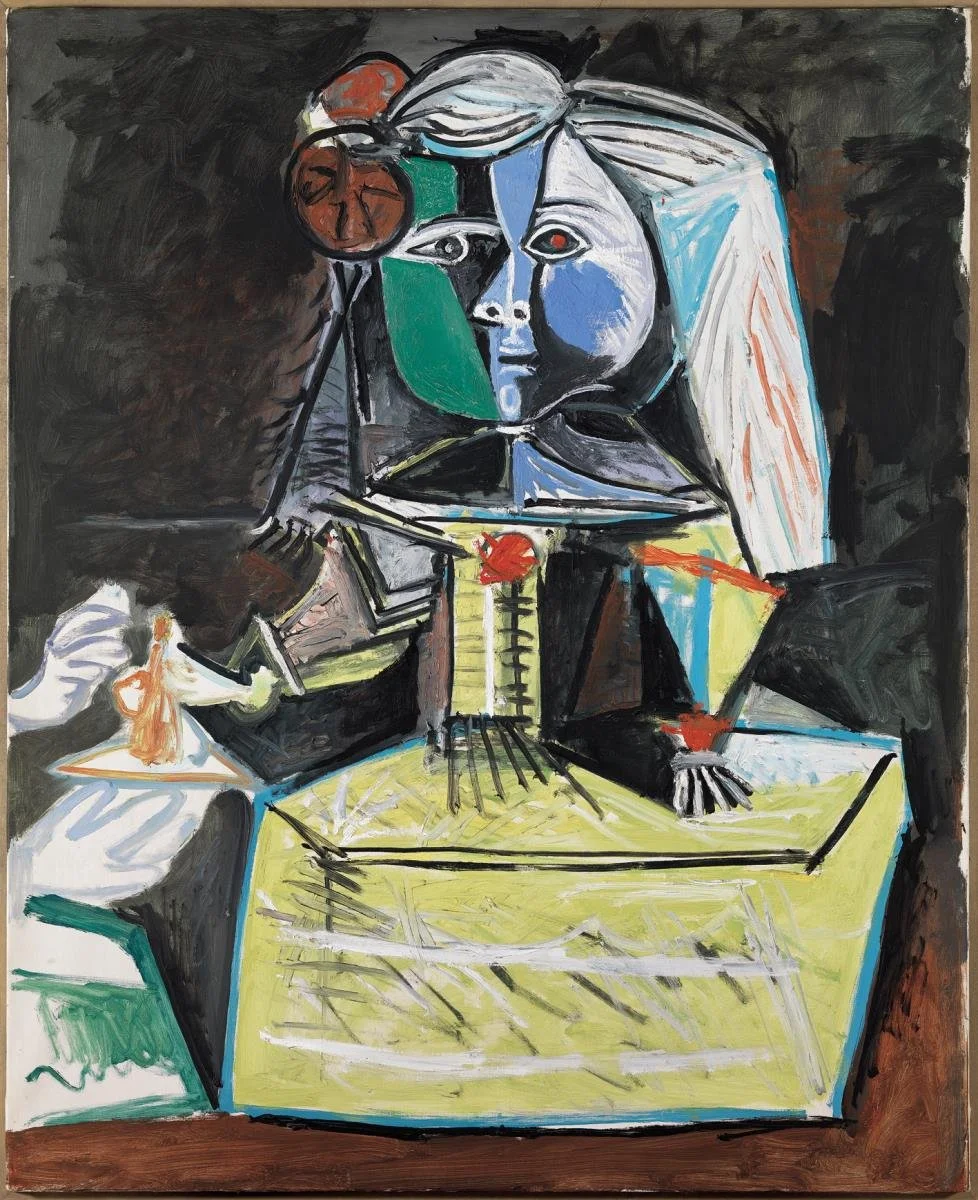 Representación artística de una figura humana con rostro dividido en colores azul, blanco, negro y verde, rodeada de objetos y formas abstractas en colores vibrantes, en un estilo cubista.