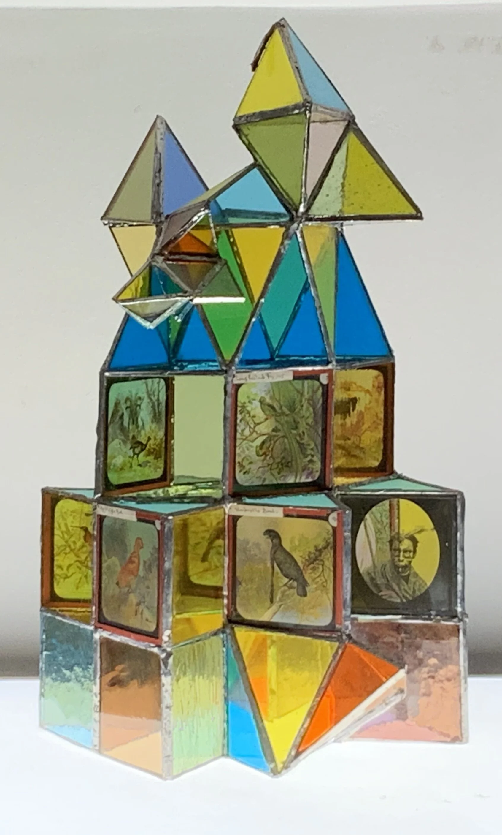 Architecture for an Extinct Planet: Birds of Paradise, 2017, Coloured glass, magic lantern slides, copper tape and solder  27 x 30 x 54cm