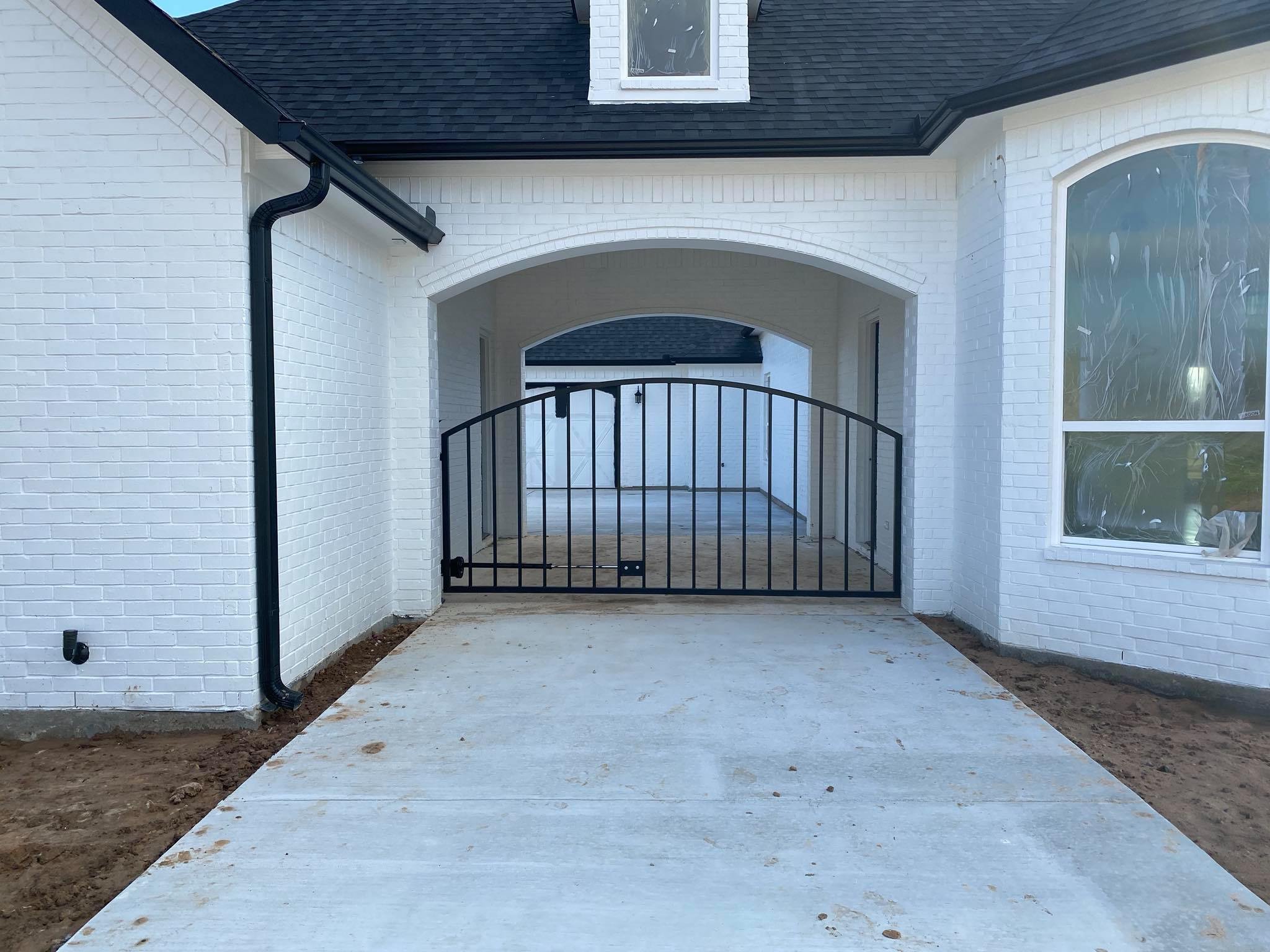 custom gate on white brick house.jpg